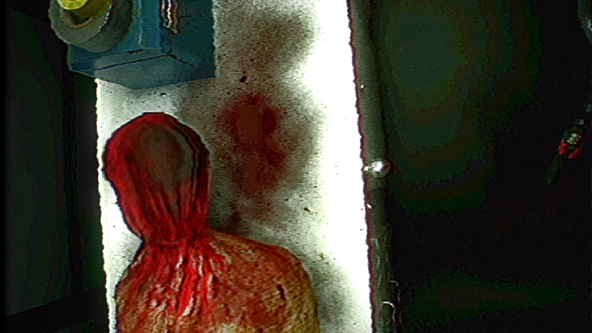 FEAR OF SLEEP: Blood-smeared figure slumped by a white pillar in a dark, grainy corridor