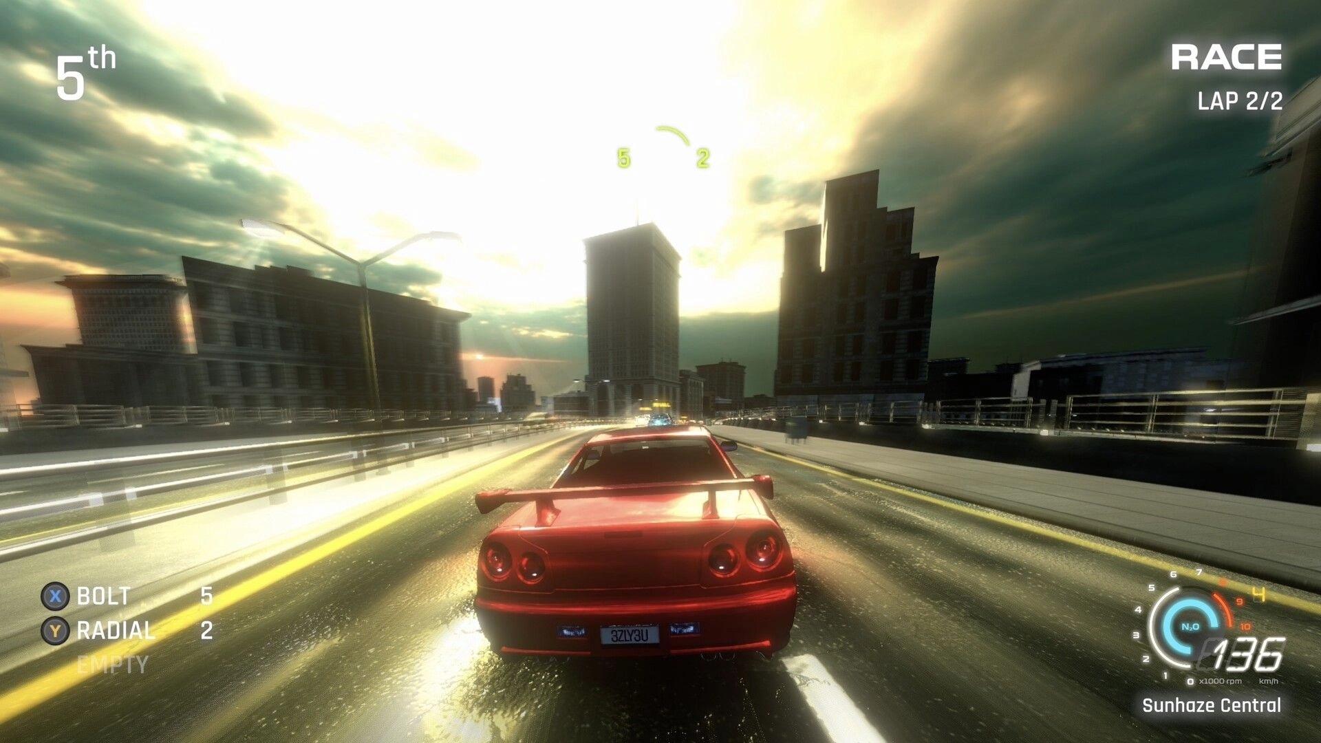 FENDERSHOT: Red sports car racing on sunlit city highway, HUD shows 5th place, lap 2/2, 136 km/h.