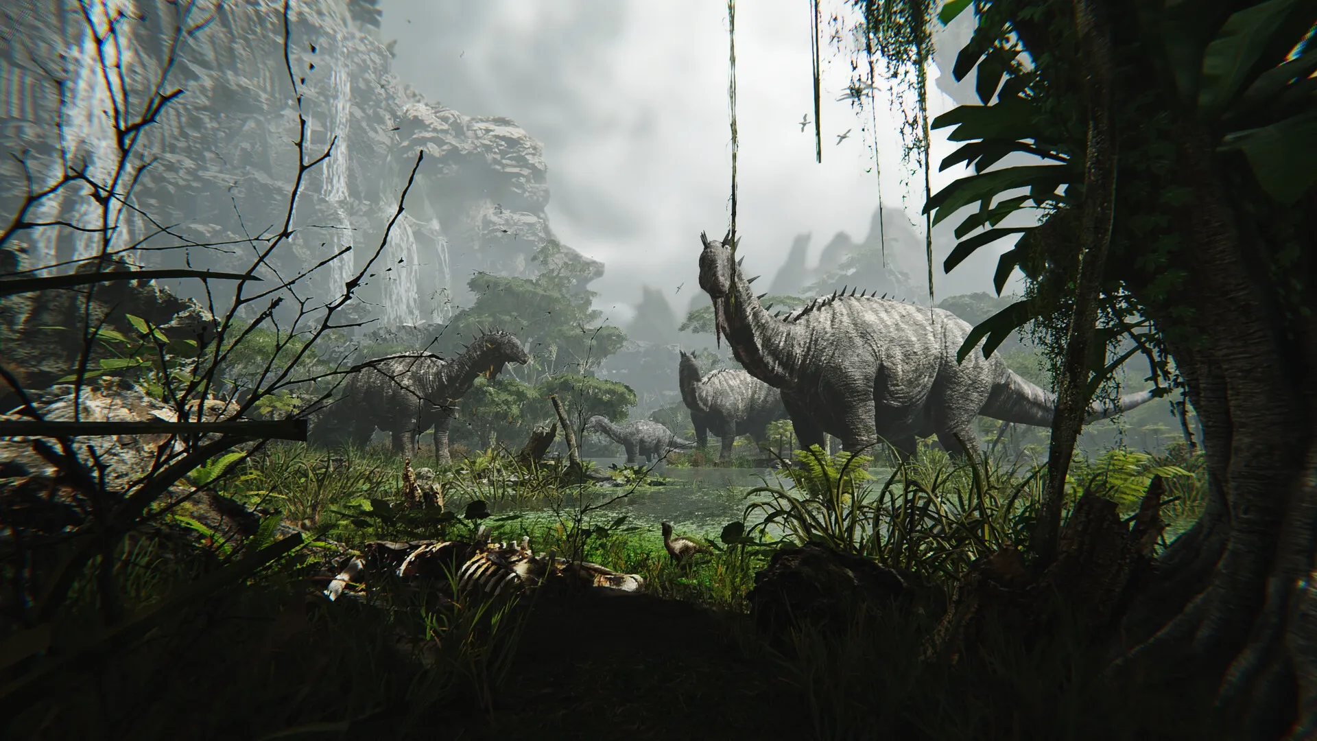 FEROCIOUS: Dinosaurs roam lush jungle with waterfalls cascading from towering cliffs in the background.
