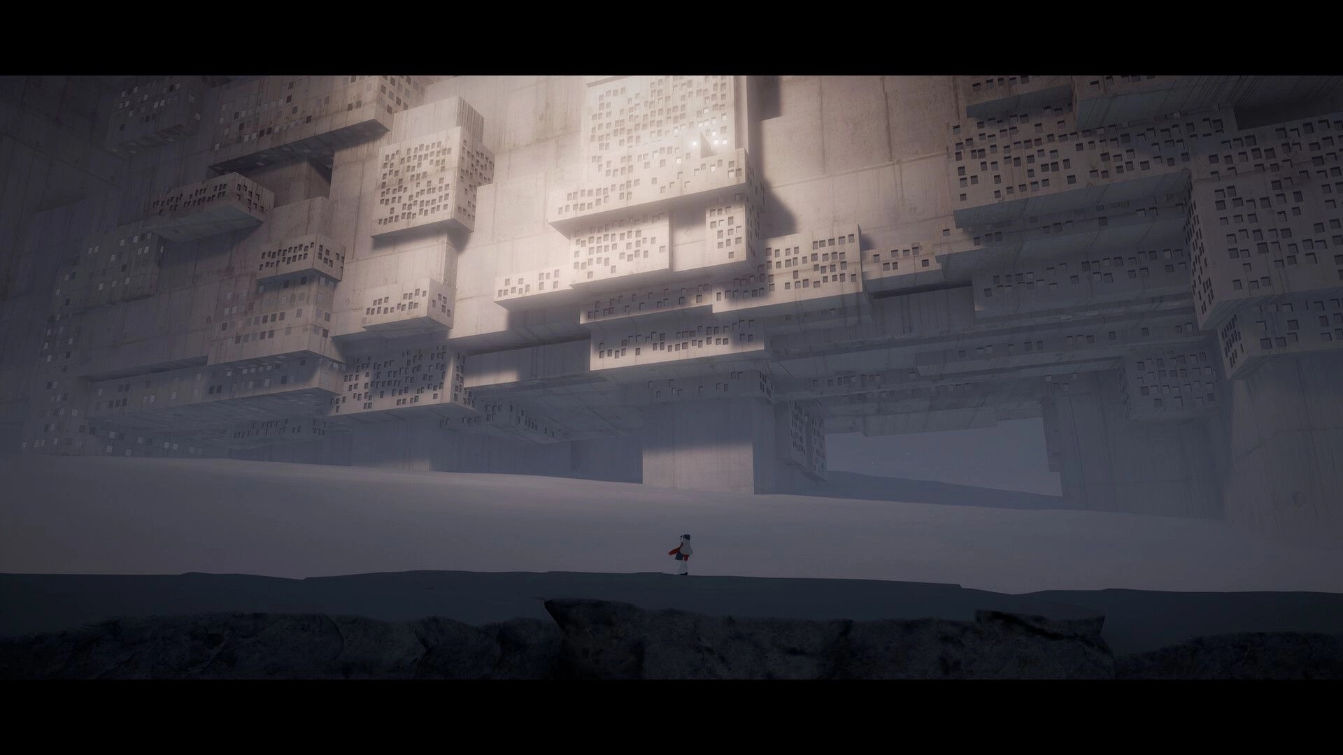 Fimbulstray: Lone girl in red scarf walks across snow beneath towering blocky concrete ruins.