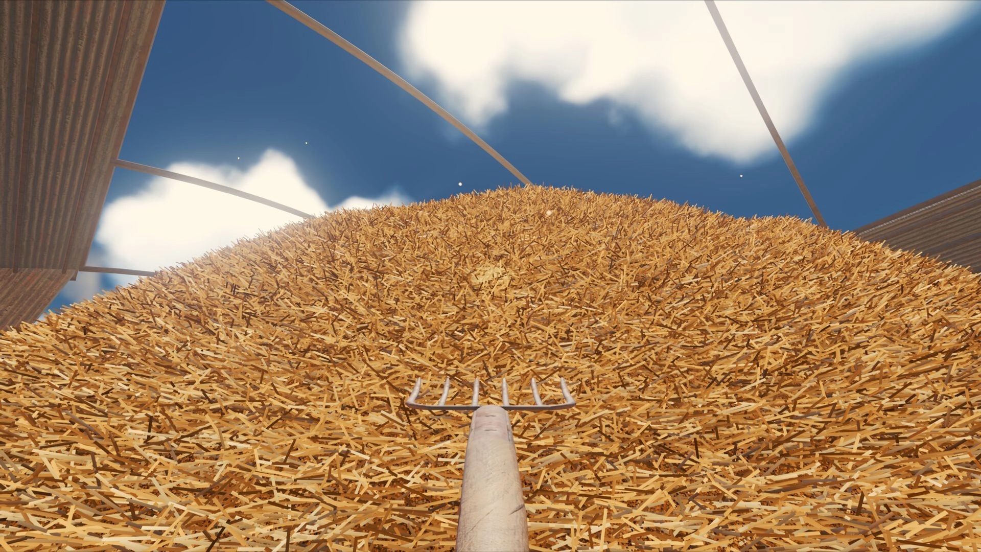 Find The Needle: First-person rake aimed at massive hay mound beneath curved roof and blue sky.