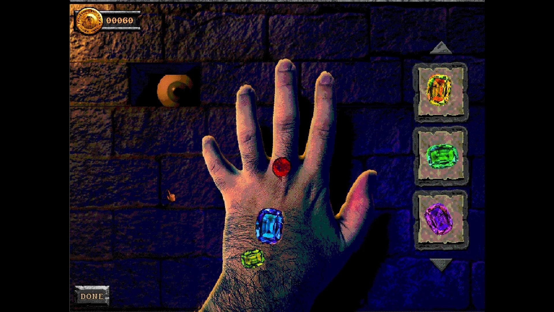 Forbidden Solitaire: Hand with three colored gems against stone wall, eye in niche, and gem menu visible