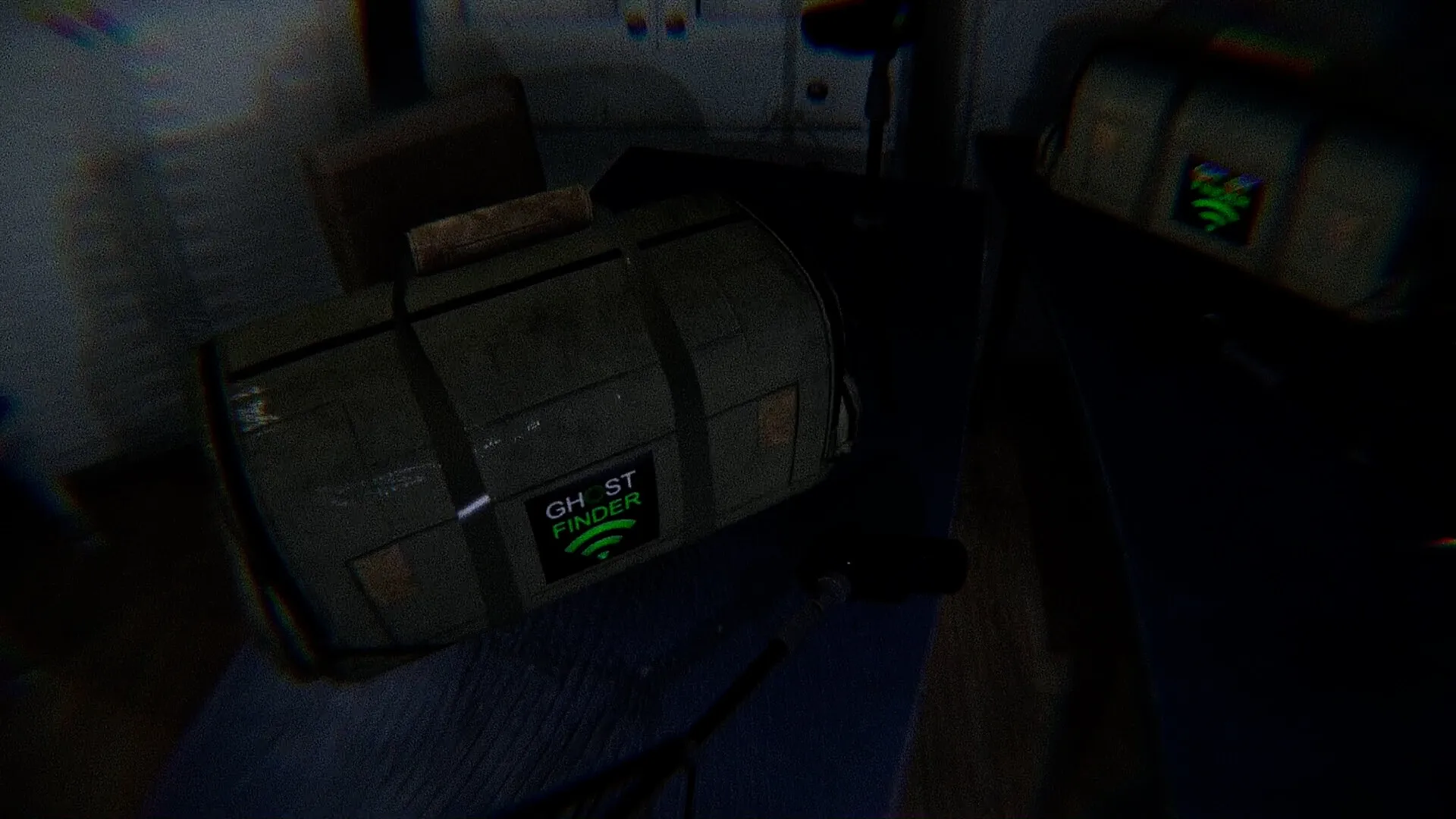 Ghost Frequency: Ghost Finder equipment case on a dark table with microphone in dimly lit room