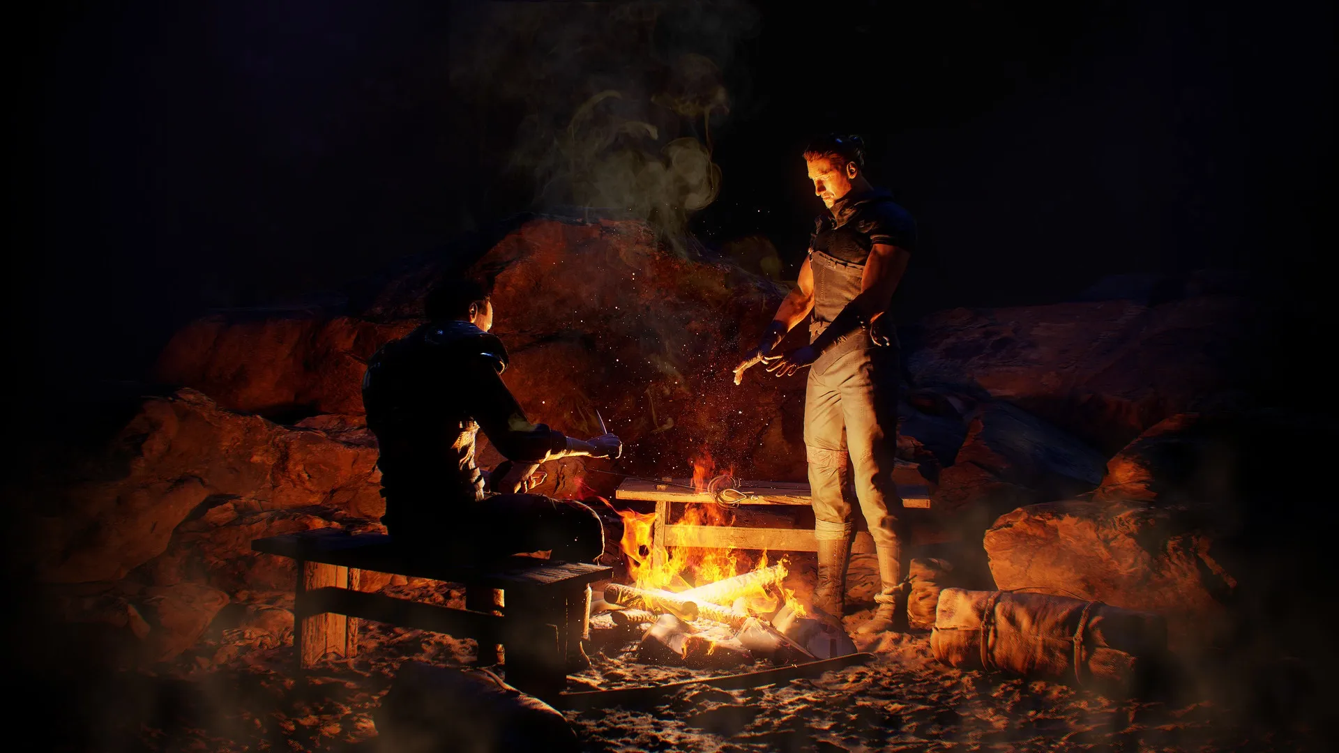 Gothic 1 Remake: Two characters warming by a campfire in a rocky, dimly lit cave environment.