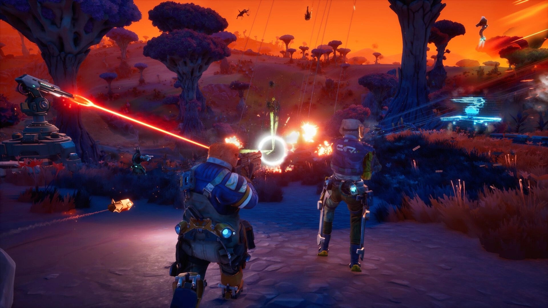 GRAVHOUNDS: Two co-op troopers fight aliens beside a laser turret in a neon forest at sunset.