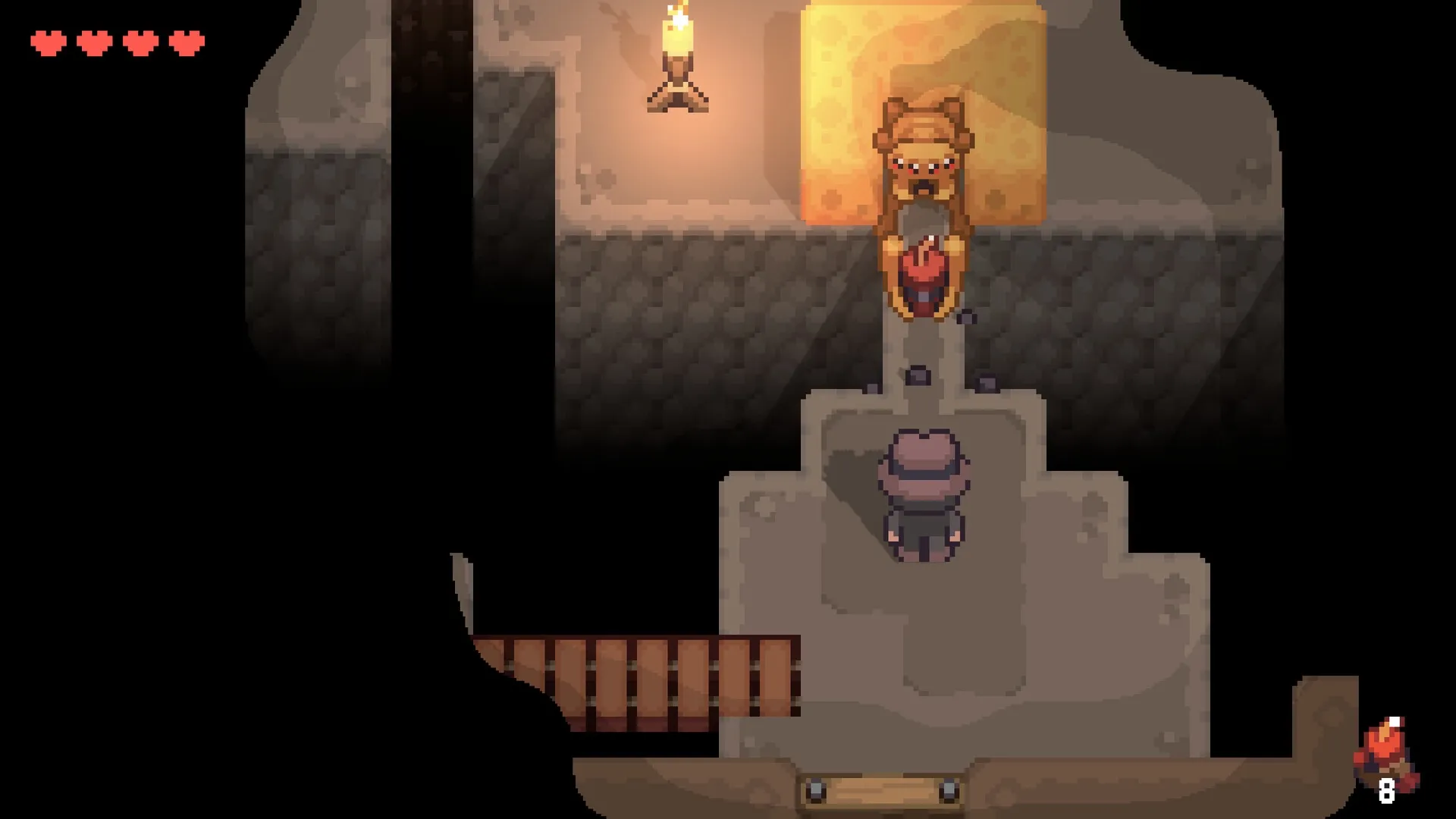 Graytail: Player encounters a character near a lit torch in a dimly lit cave with stone walls and wooden path.