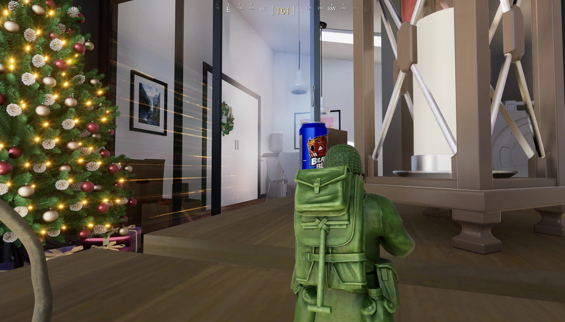 Green Hawk Platoon: Toy soldier aiming behind a can in a festive living room with a Christmas tree.