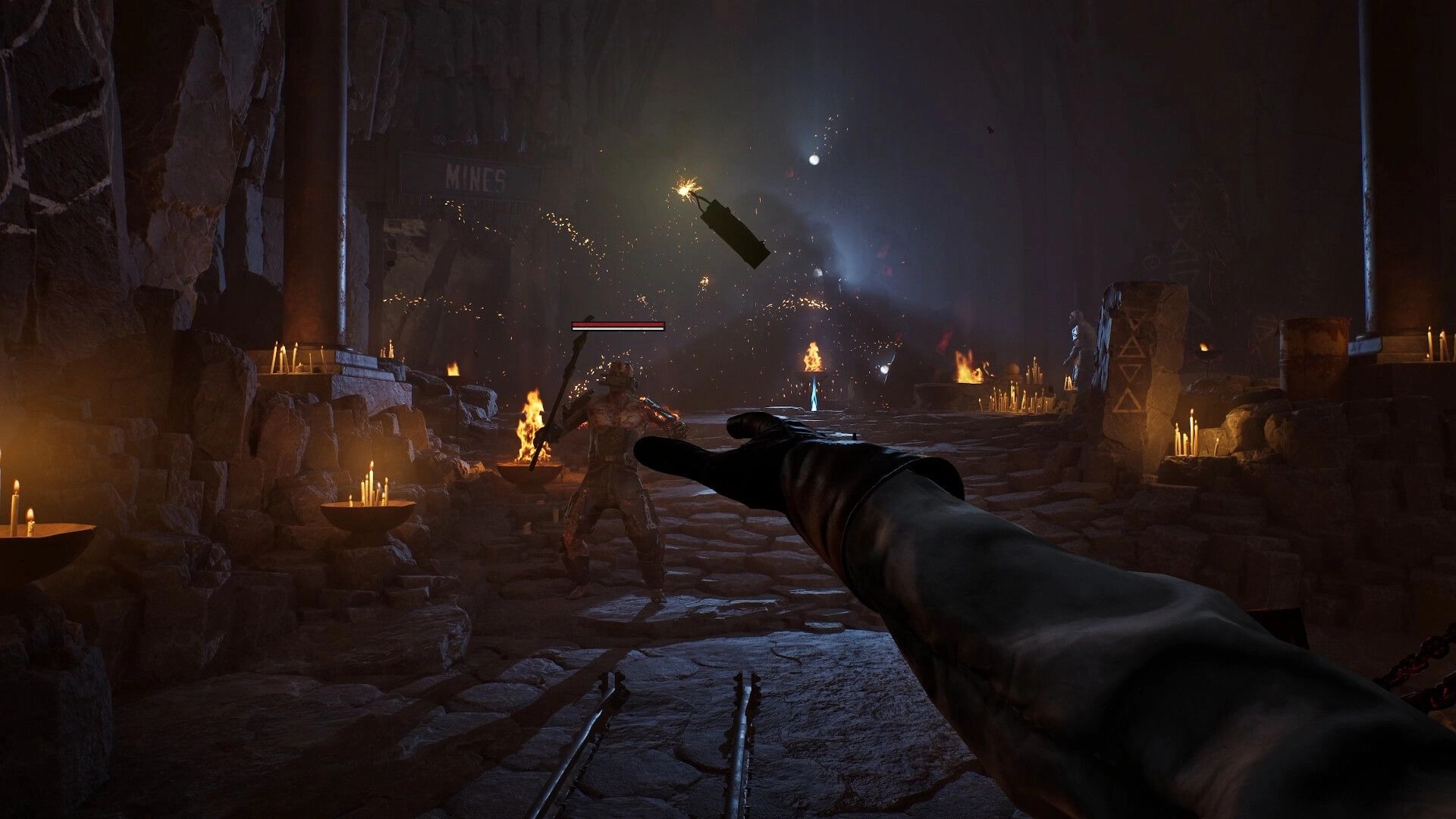 Guns of Eschaton: First-person spellcasting at a sword foe in a candlelit mine corridor with flames.