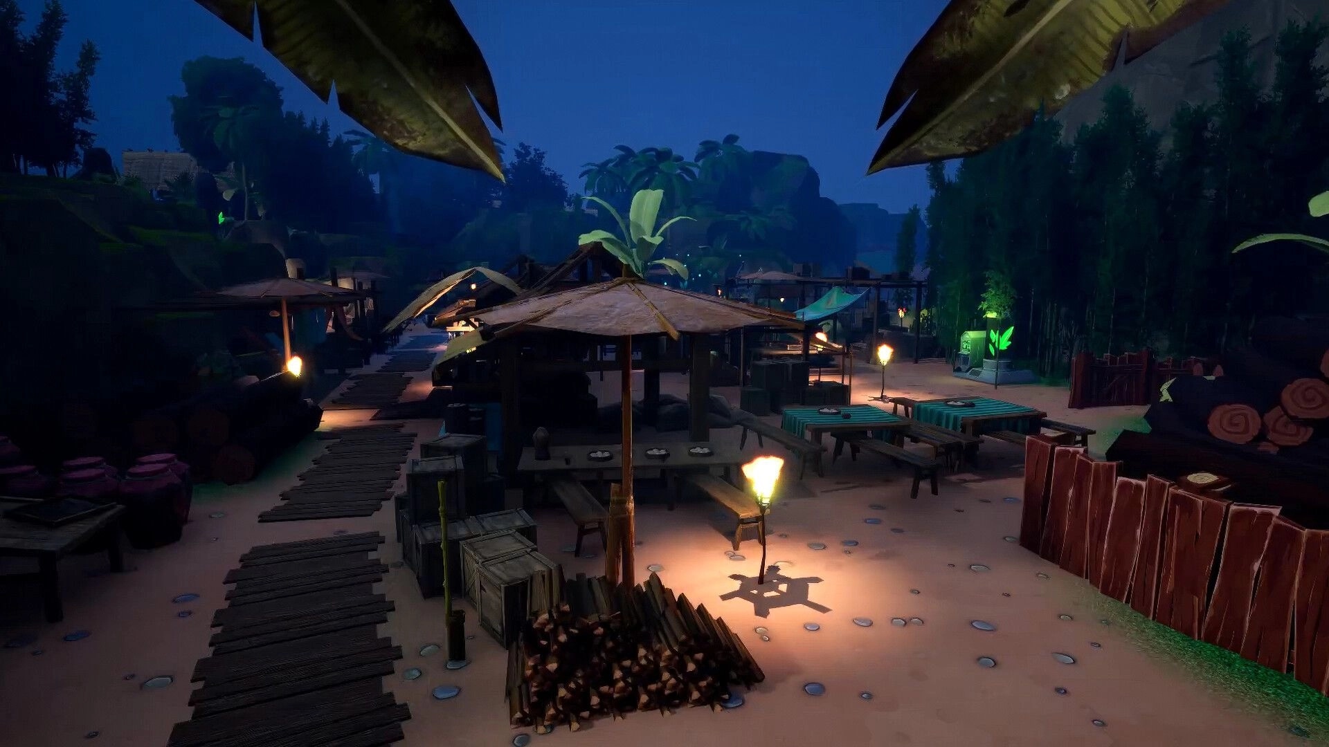 Hantu and Hunted: Torchlit beach village market with huts, tables, crates, and jungle backdrop at night.