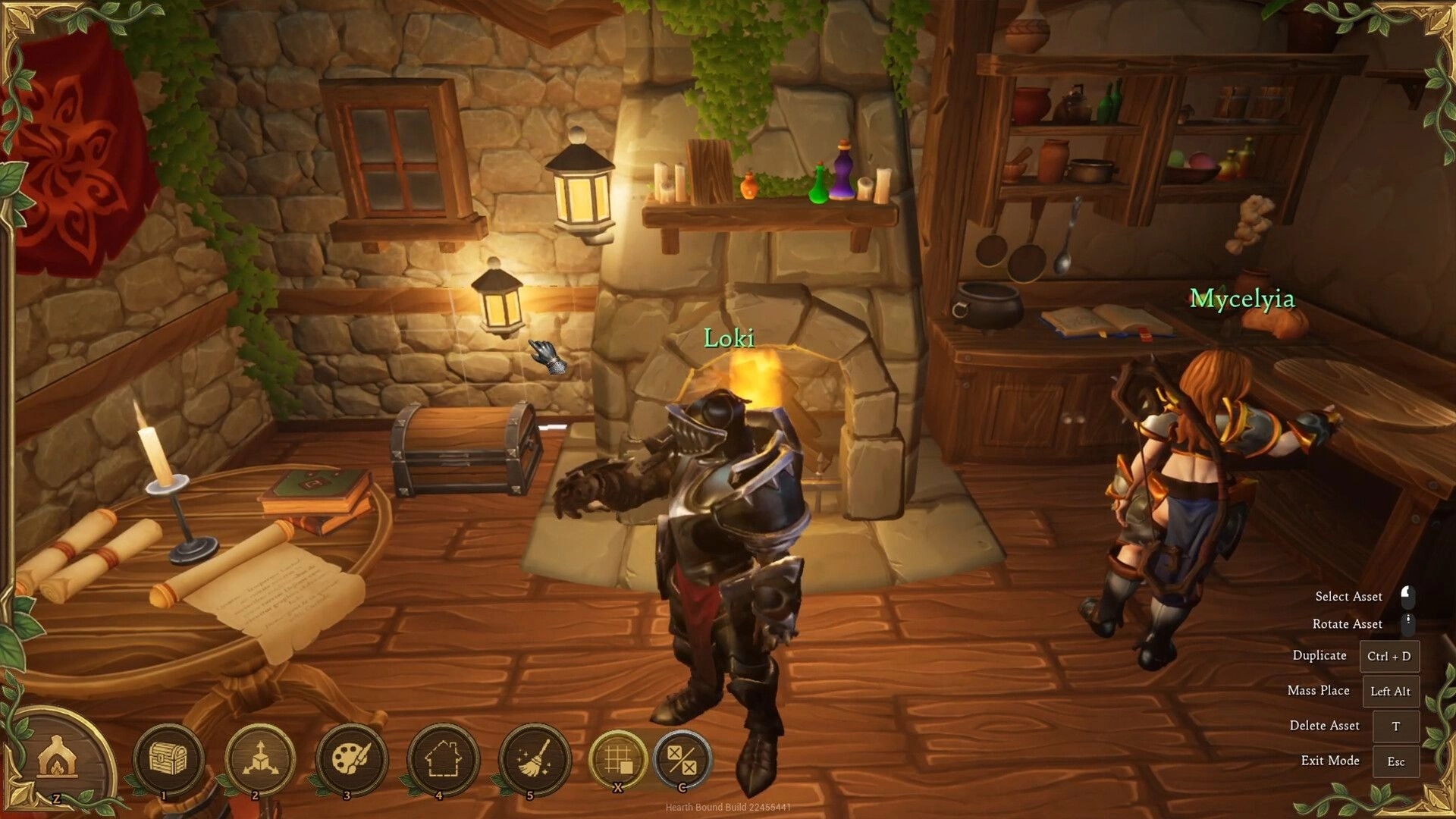 Hearth Bound: Loki and Mycelyia in build mode by a fireplace inside a cozy stone-and-wood kitchen room.