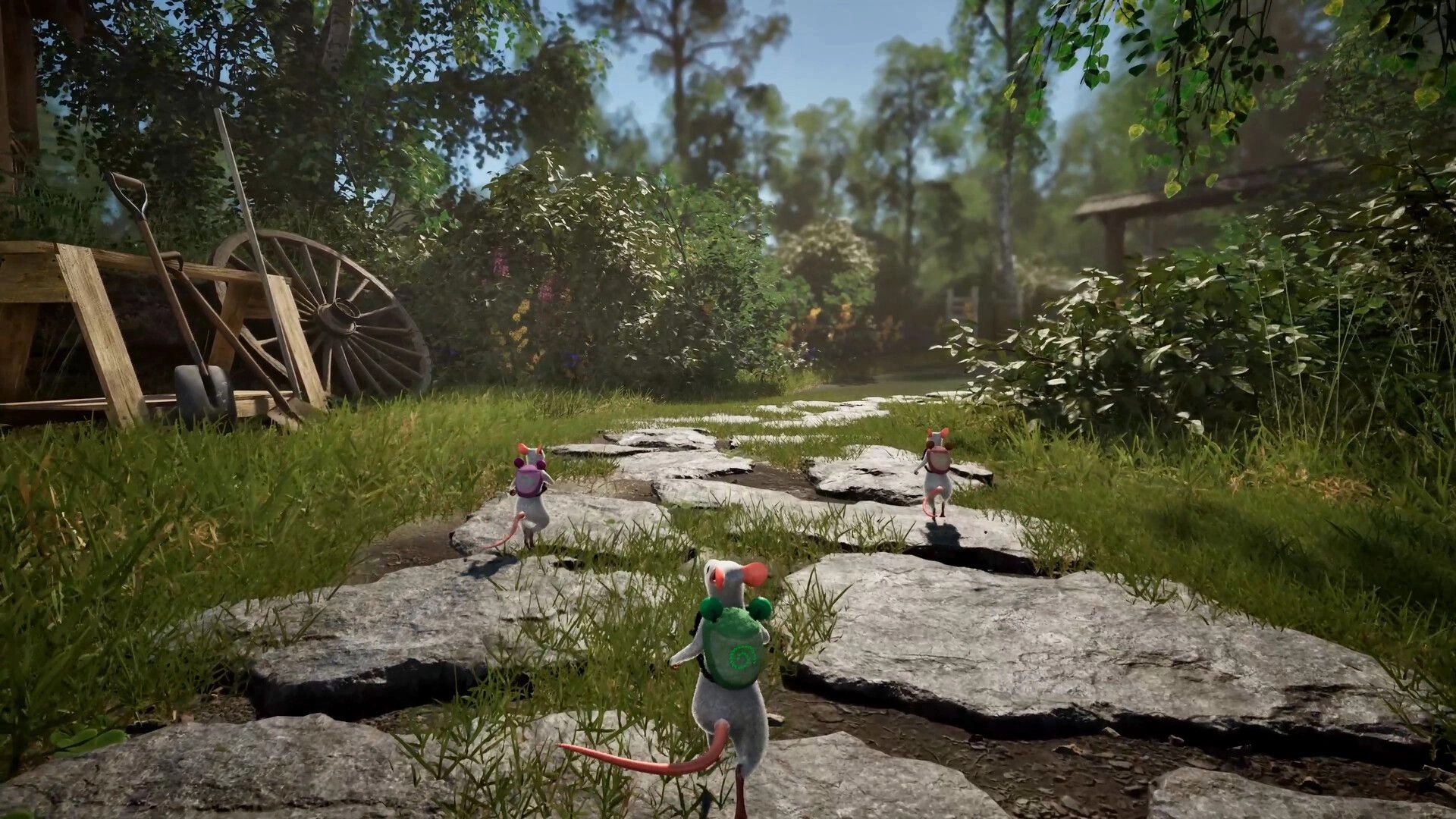 Hela: Three mice with backpacks walk along a stone path through a lush garden with cart wheel nearby.