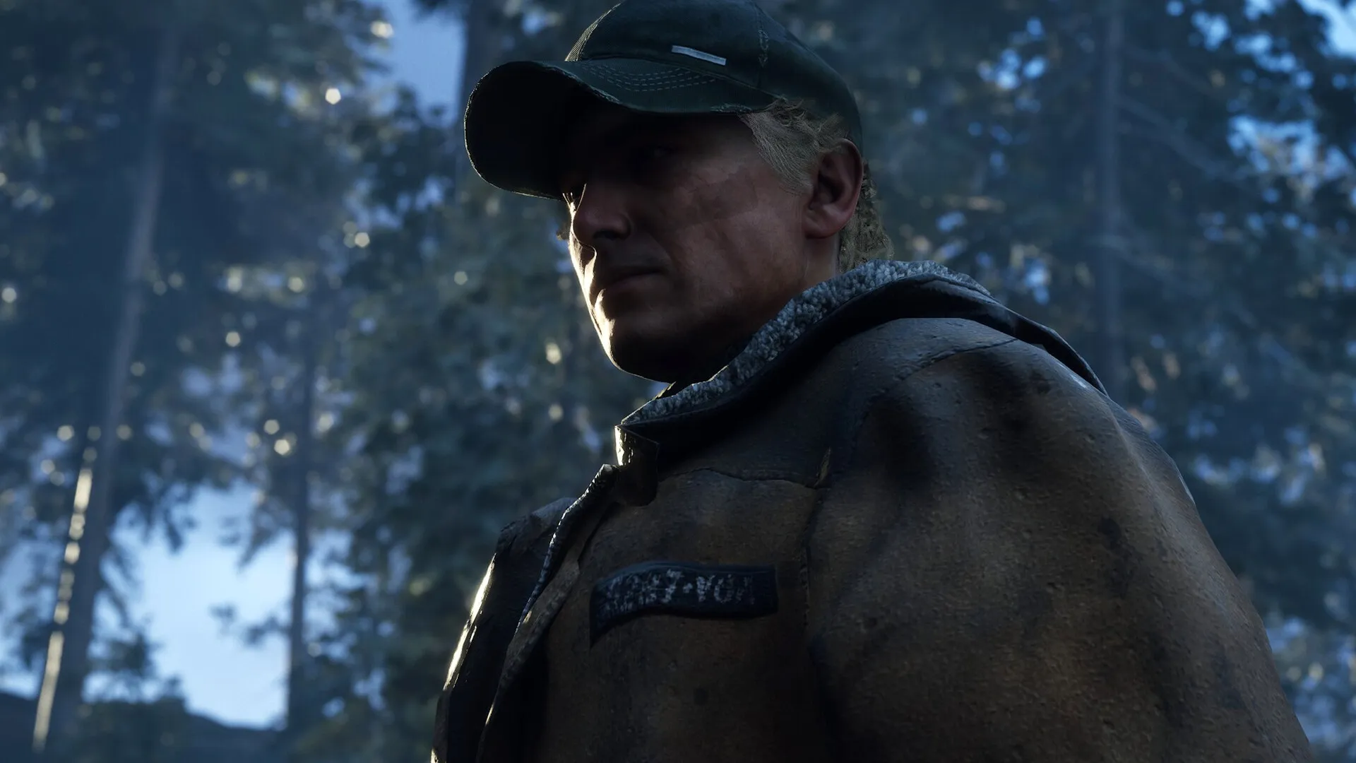 Hell is Us: Character in rugged clothing stands in forested area, light casting shadows on their face