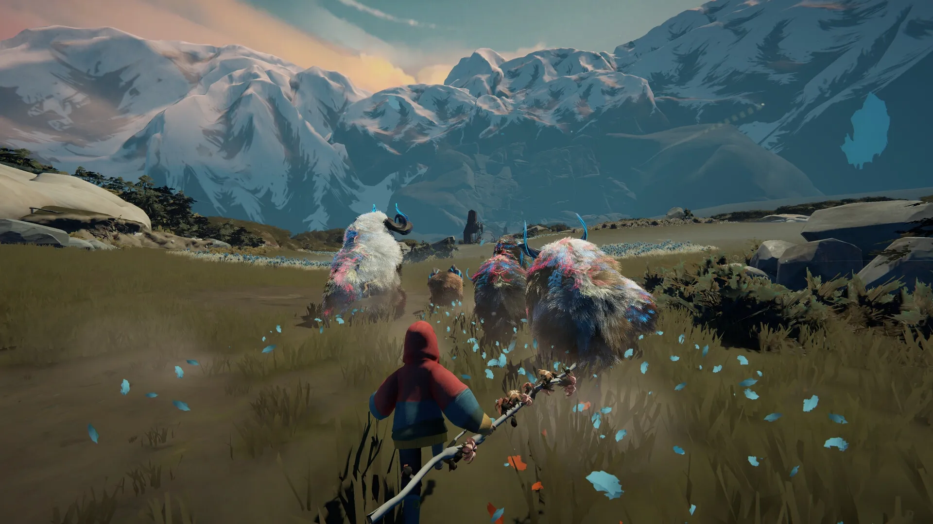 Herdling: Player guides colorful creatures across grassy plains with snowy mountains in the background.