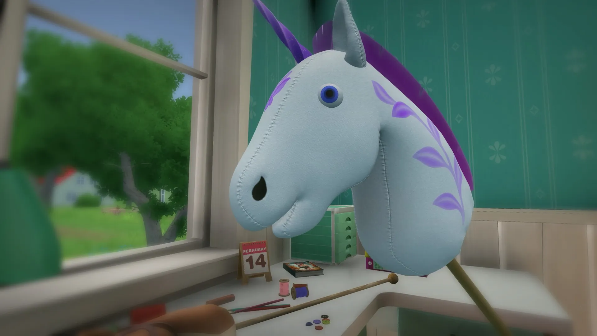 Hobby Horse: Blue hobby horse head with purple mane on crafting table near window overlooking green yard