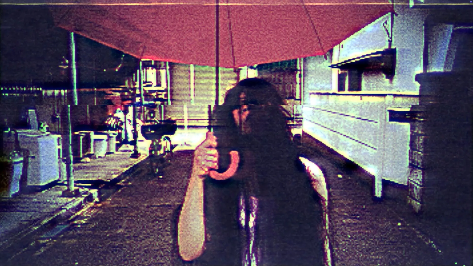 HOTEL BARCELONA: Mysterious figure with long hair holding red umbrella in dimly lit alleyway