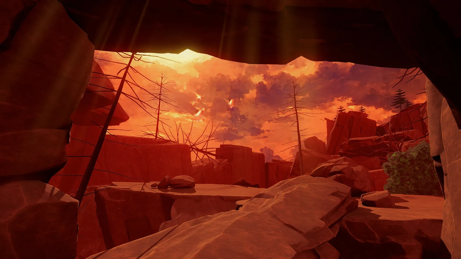 I Mother: Rocky canyon landscape at sunset with sparse trees and dramatic sky visible from cave opening