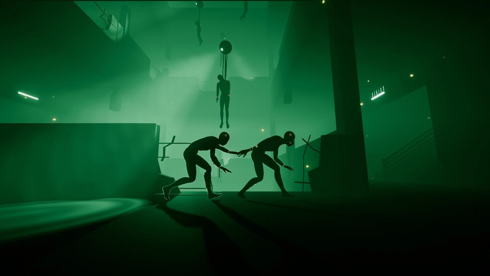 IN SILICO: Two shadowy humanoids creep past a hanging body in a green, foggy industrial cavern.