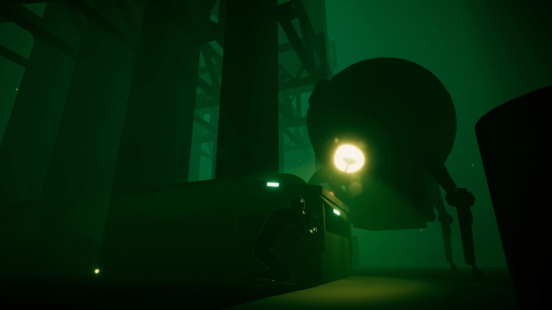 IN SILICO: Silhouetted figure crouches by a control panel under a giant green-lit sphere in a lab.