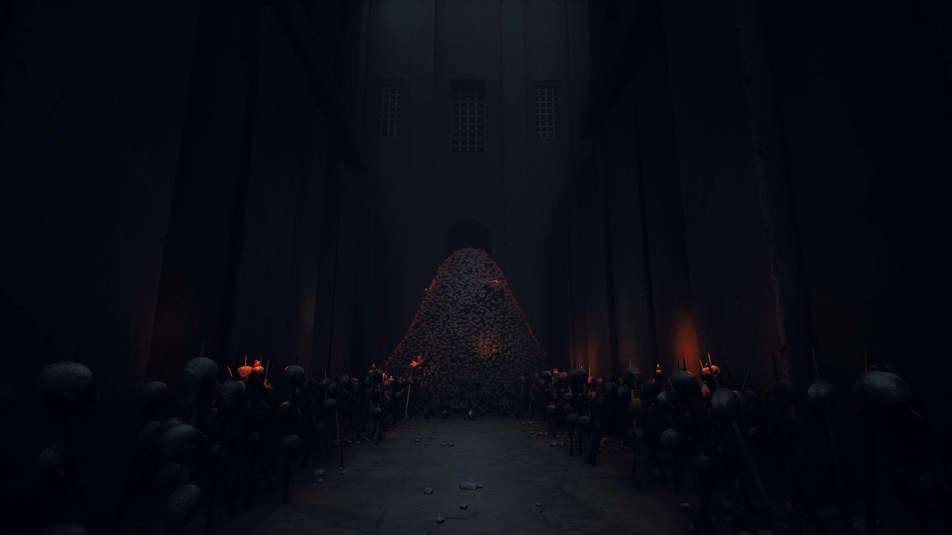 INFERIUS: View of a skull mound lit by candles in a shadowy stone hall with light beams above.