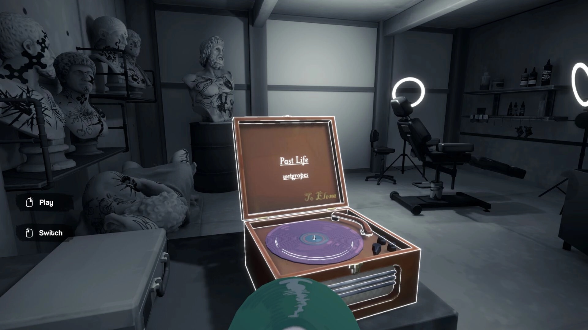 Inkression: Vinyl record player in tattoo studio with sculptures and tattoo chair visible in background