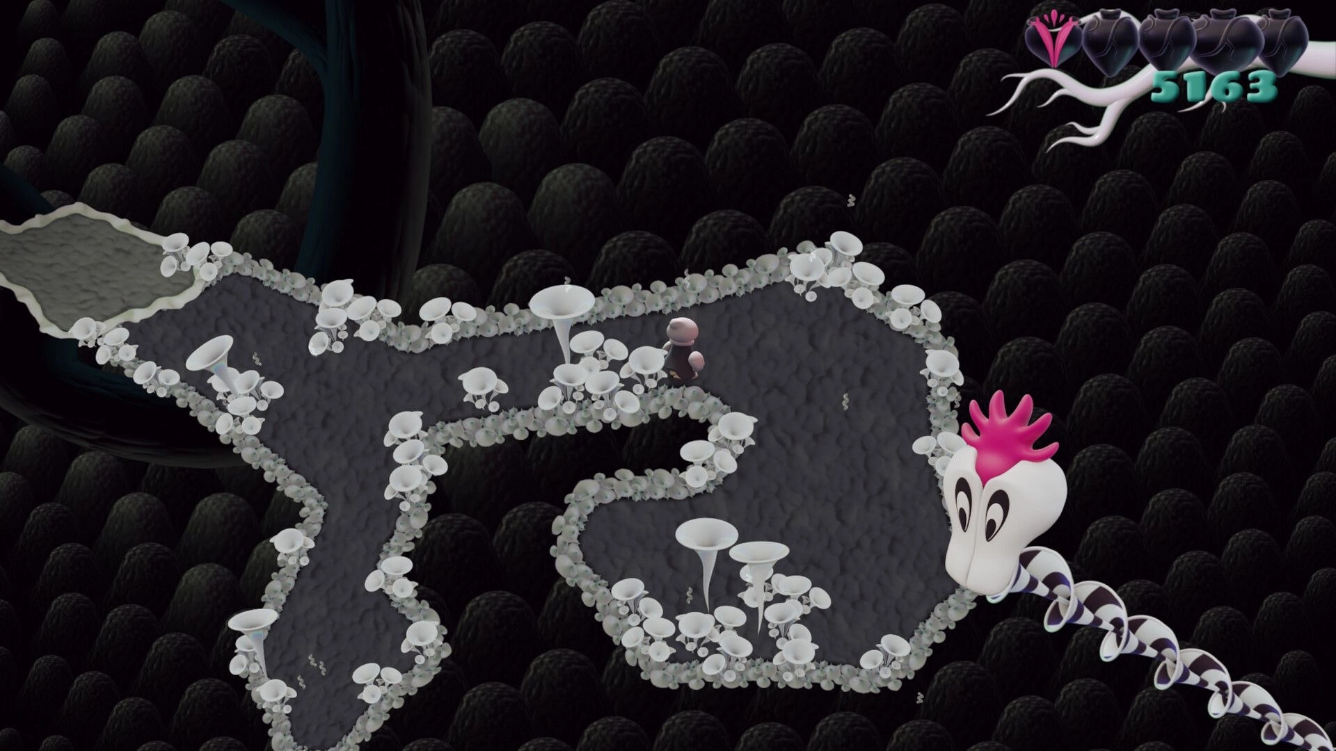 Innards: Small figure walks a gray path lined with white pods in dark cavern, hearts and score UI top right.