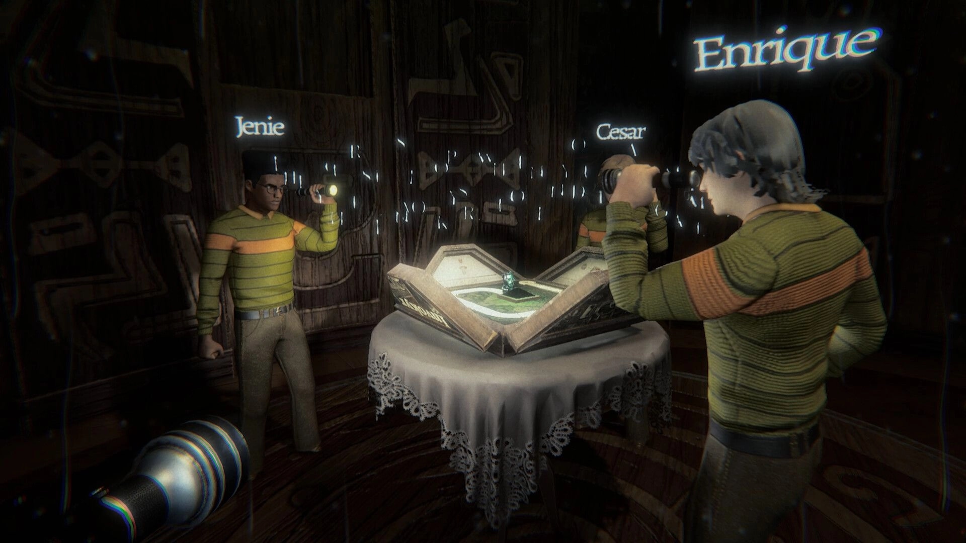 Invokyr: Enrique, Jenie and Cesar aim flashlights at an open board game on a table in dark room.