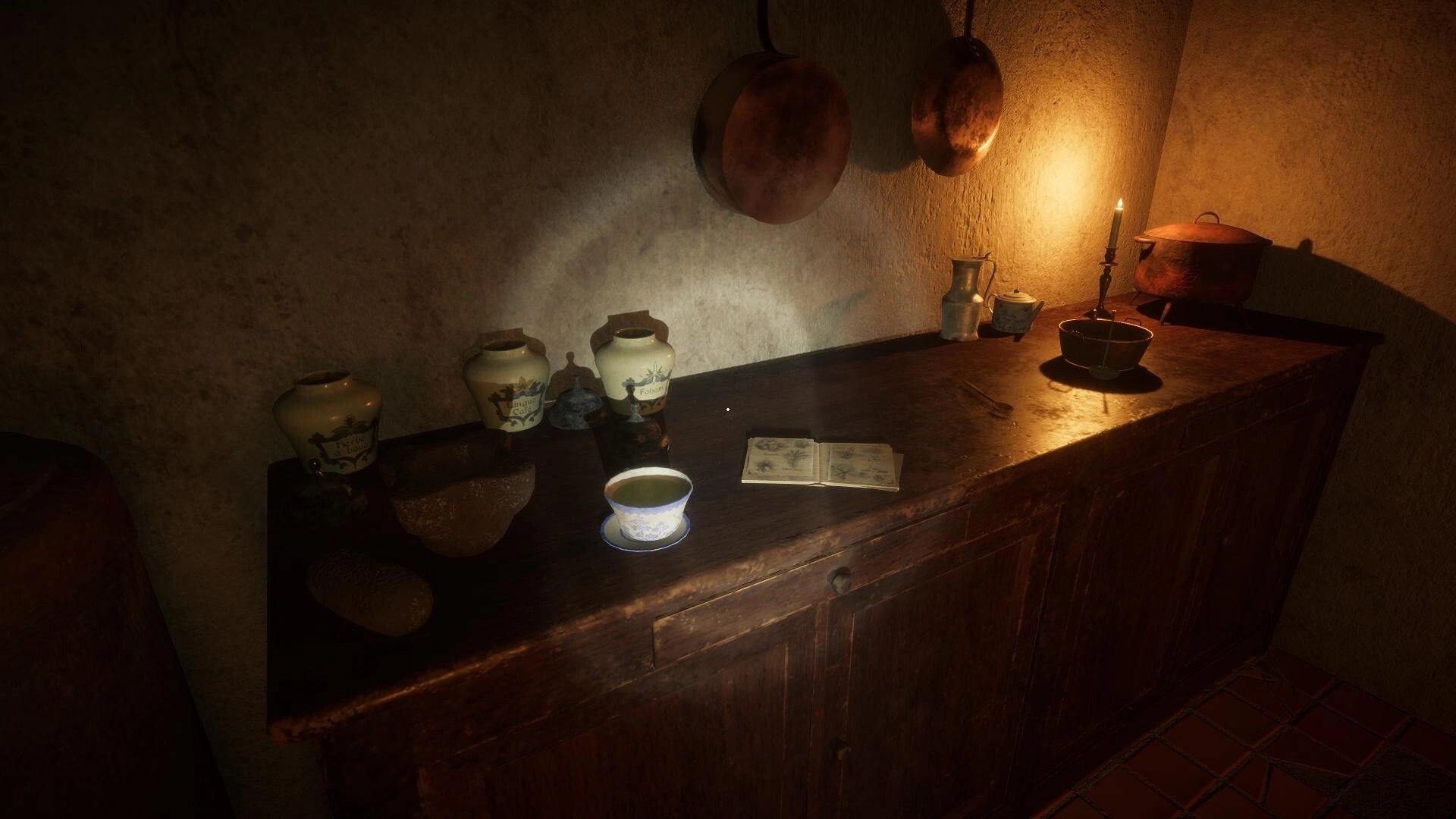 KAL: Dimly lit kitchen with pots, candle, and an open book on a wooden counter in an old house.