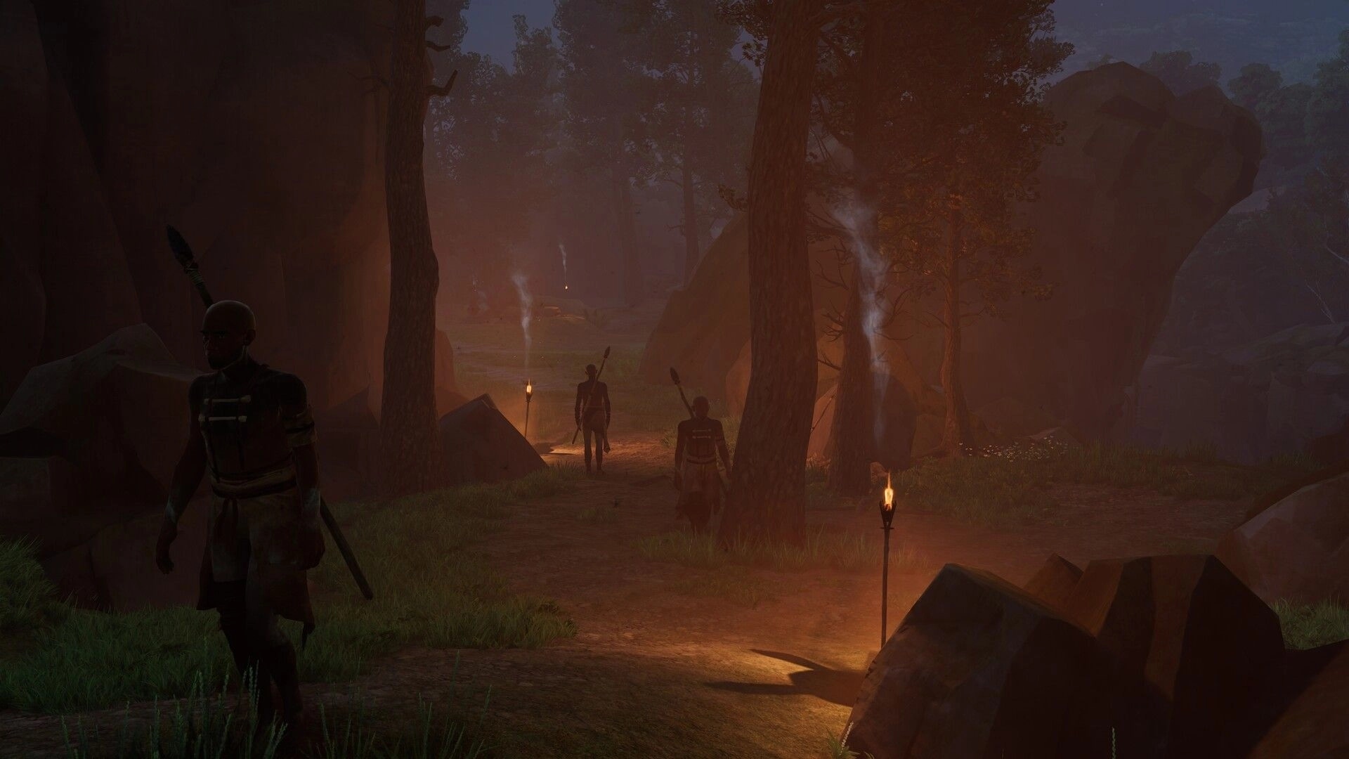 Kiipluu: Three spear-wielding figures patrol a torchlit trail through a misty forest canyon at dusk.