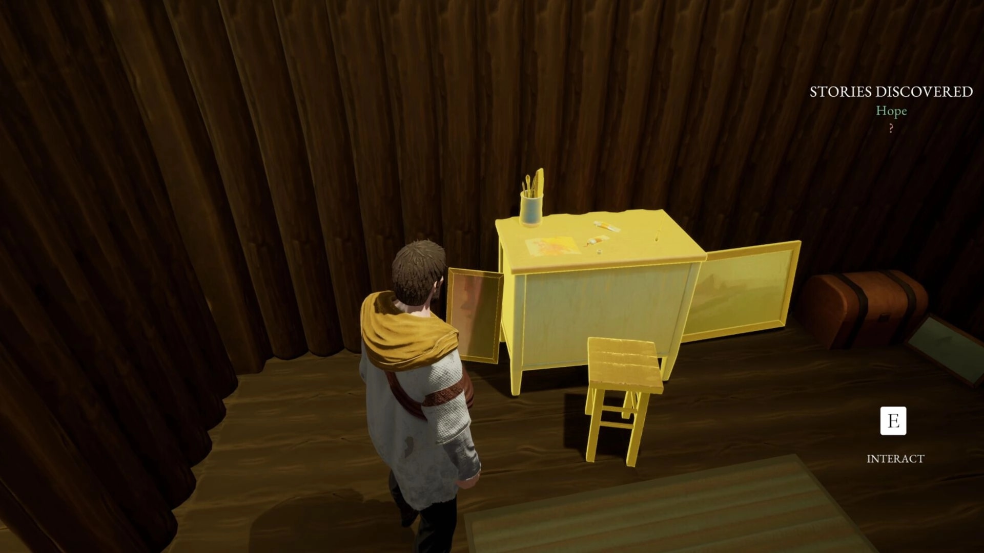 Kinsfolk: Player character examines a yellow desk with an open drawer in a wooden cabin interior.