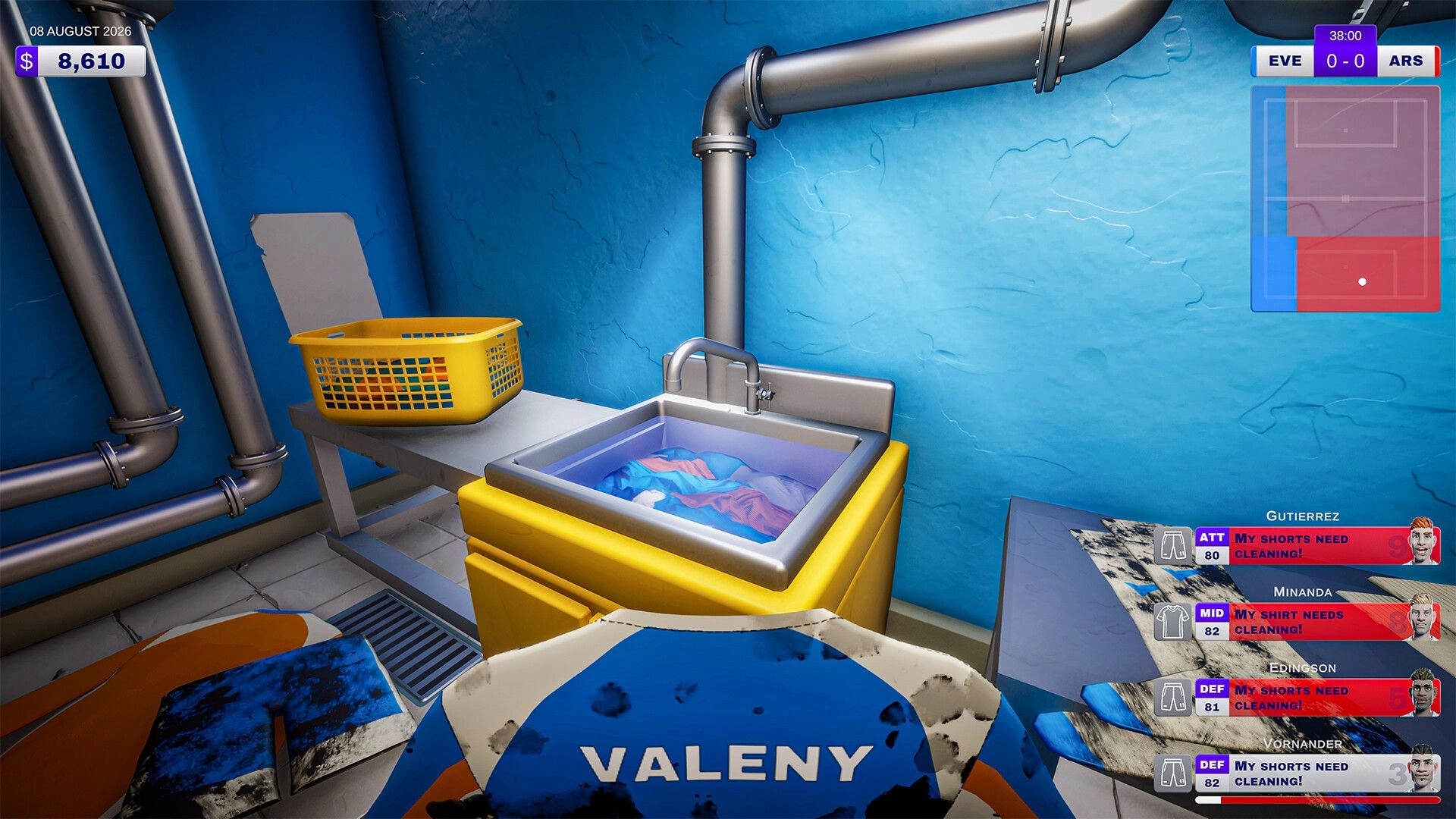Kitman: Washing muddy team kit in a utility sink, with player needs list UI in laundry room.