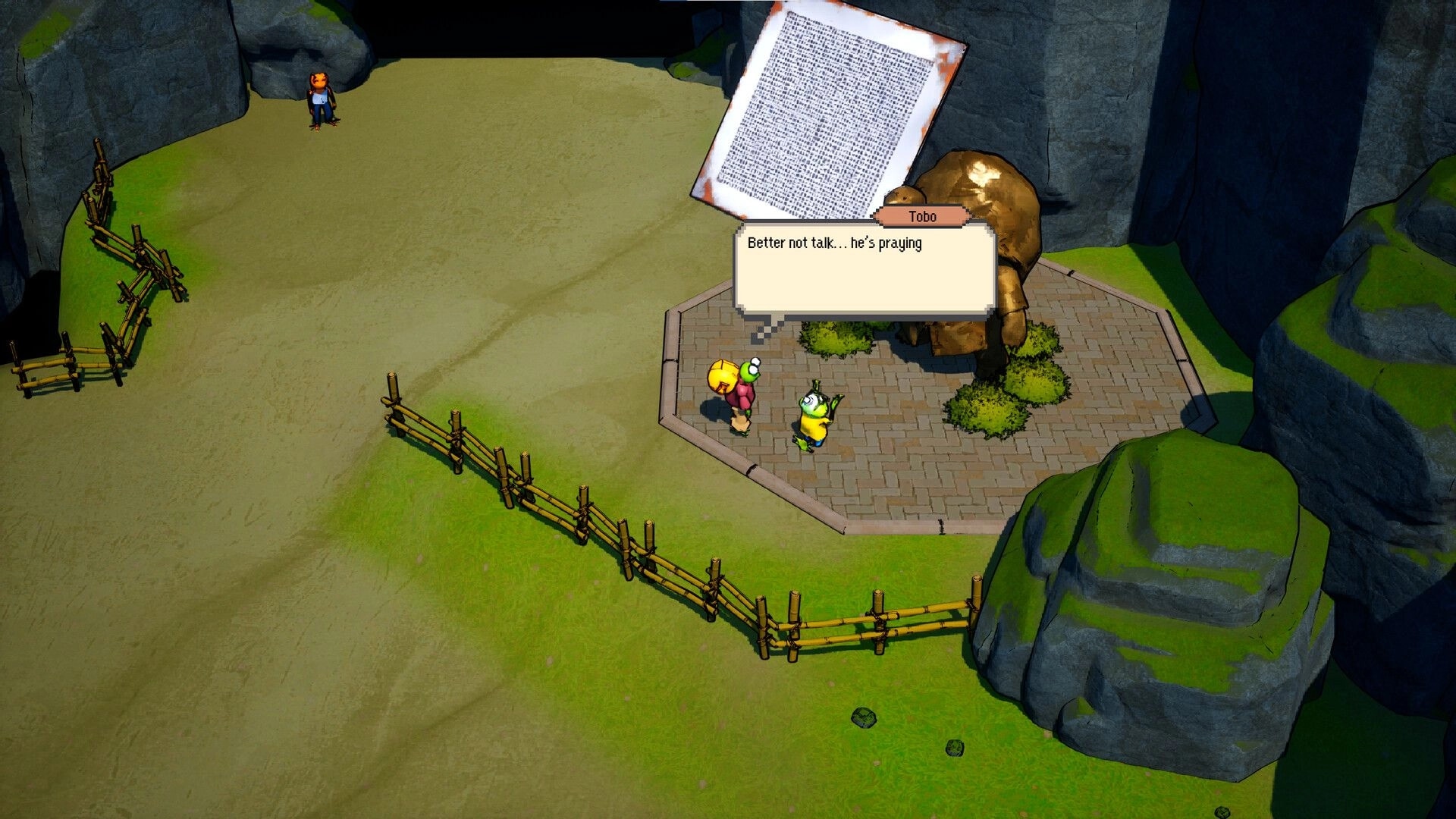 Kodoktale: Tobo and friend converse near a statue in a fenced village area with rocky surroundings.