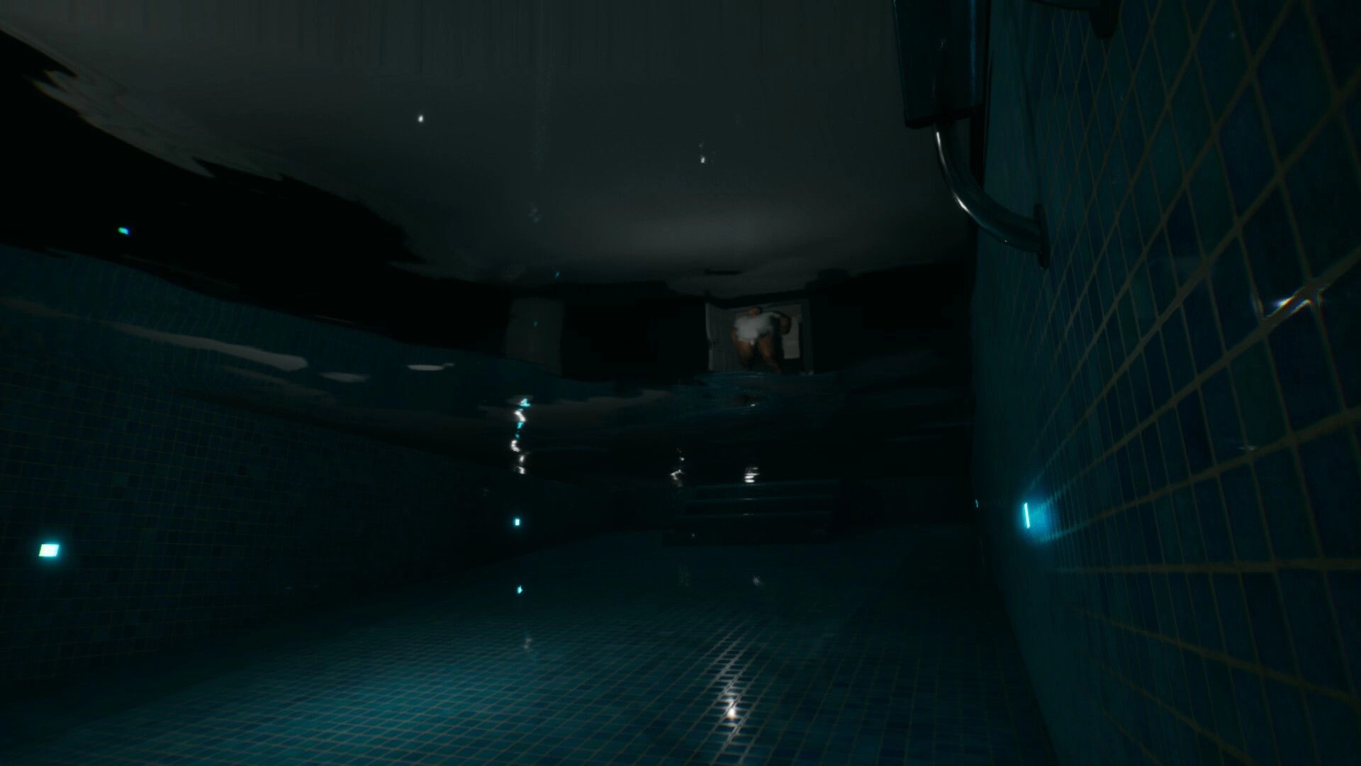 LAG KILLS: Underwater view in a tiled pool with rippling surface and a figure near the edge above.