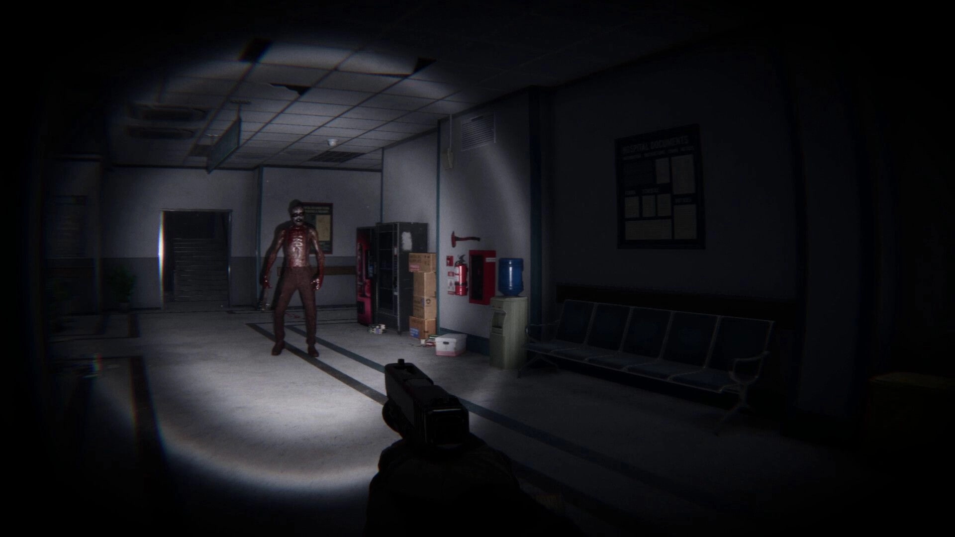 Lens Of Fear: First-person gun aimed at bloodied man in a dim hospital hallway with benches and lockers.