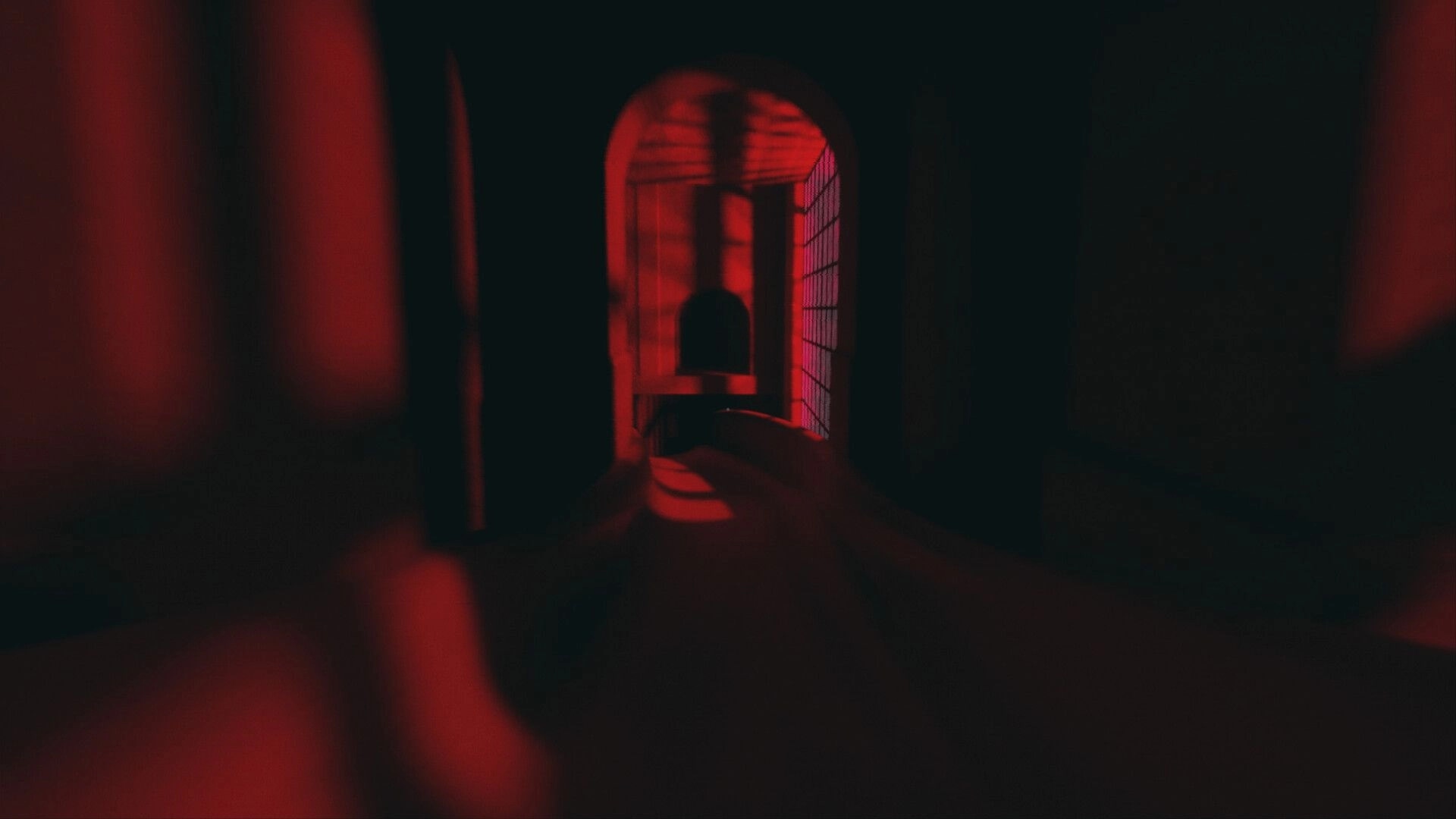 Liminal Shroud: Dimly lit red corridor with eerie shadows and arched passageways creating a foreboding atmosphere
