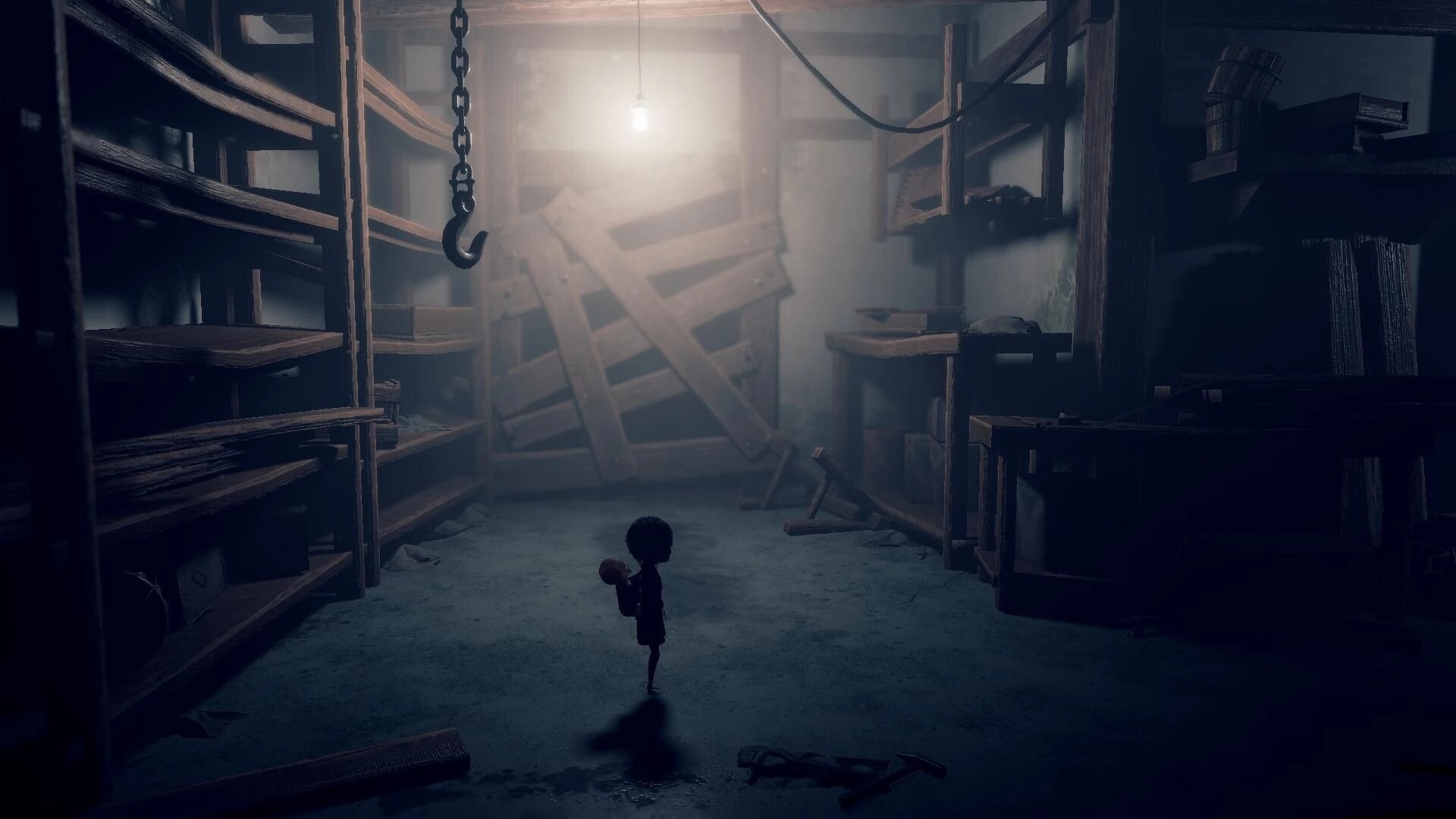 Lull: Girl with baby on her back stands in dusty storeroom with shelves, hook, boarded door.
