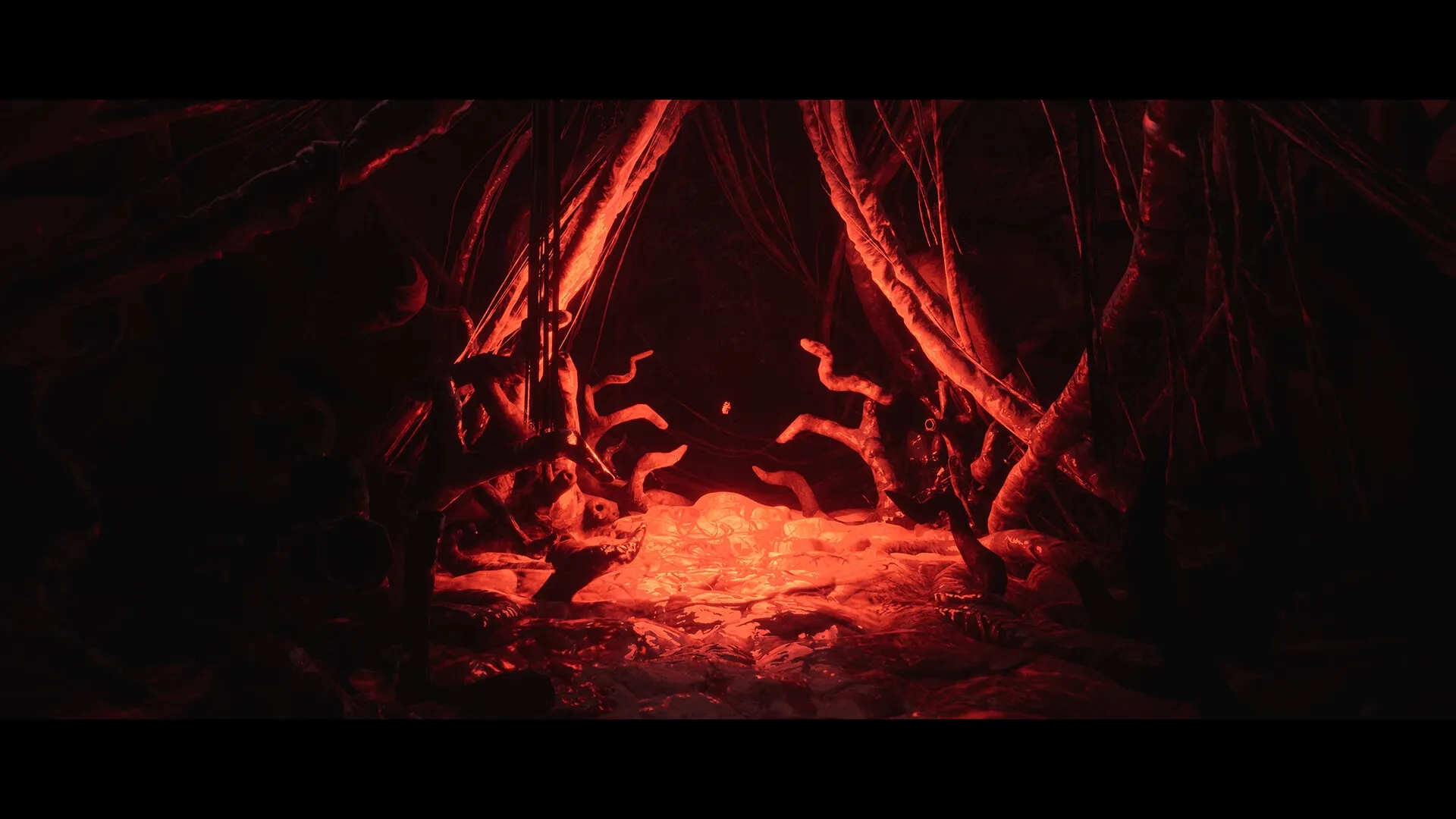 Luto: Dark cavern with glowing red light and twisted branches creating an eerie, foreboding atmosphere.