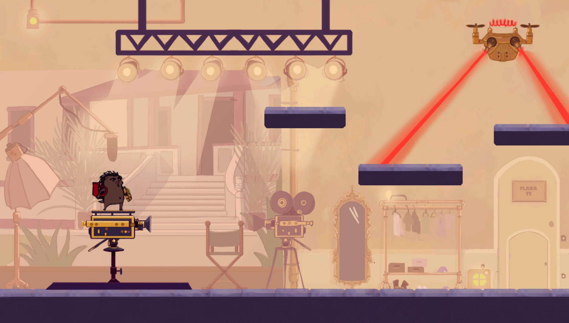 Mangut: Gil stands on a camera platform avoiding red laser beams in a studio with film equipment.