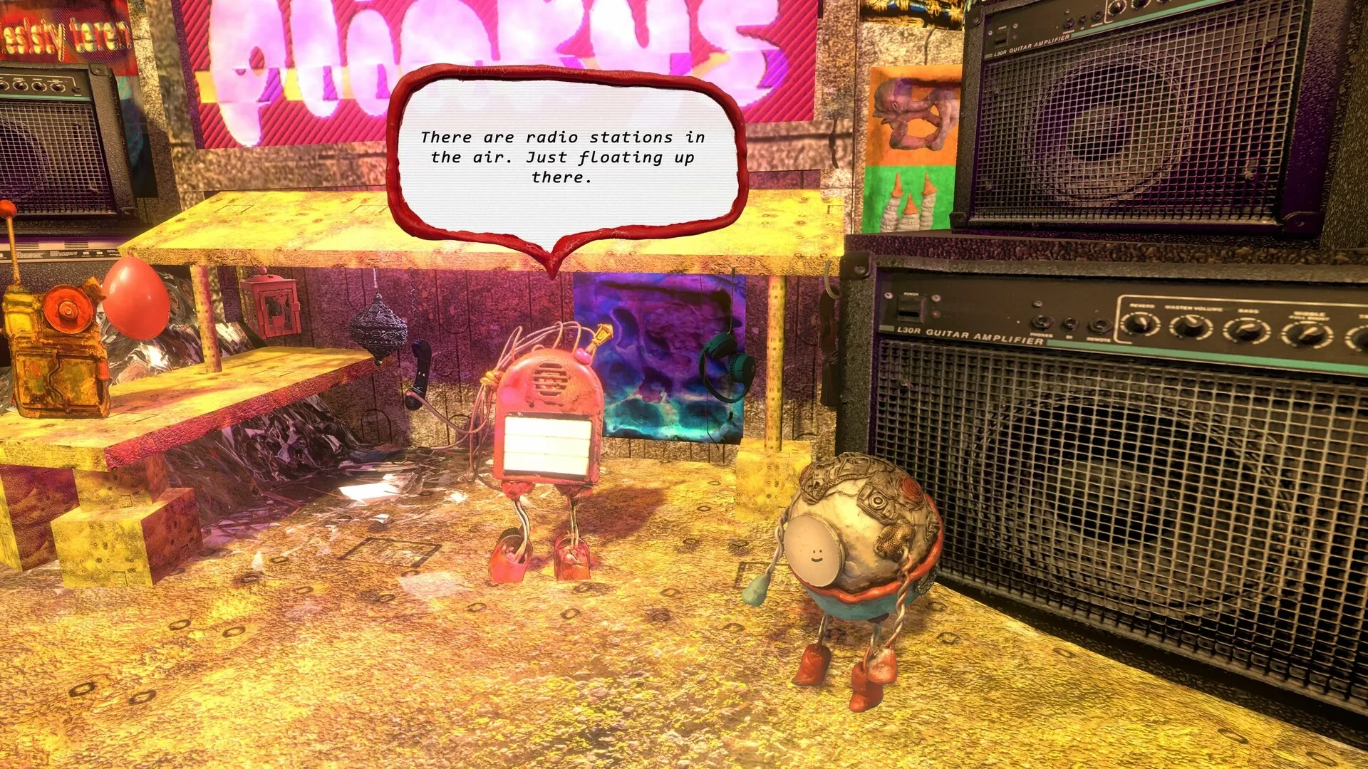 Mashina: Two quirky robots converse beside large speakers in a colorful, cluttered workshop environment.