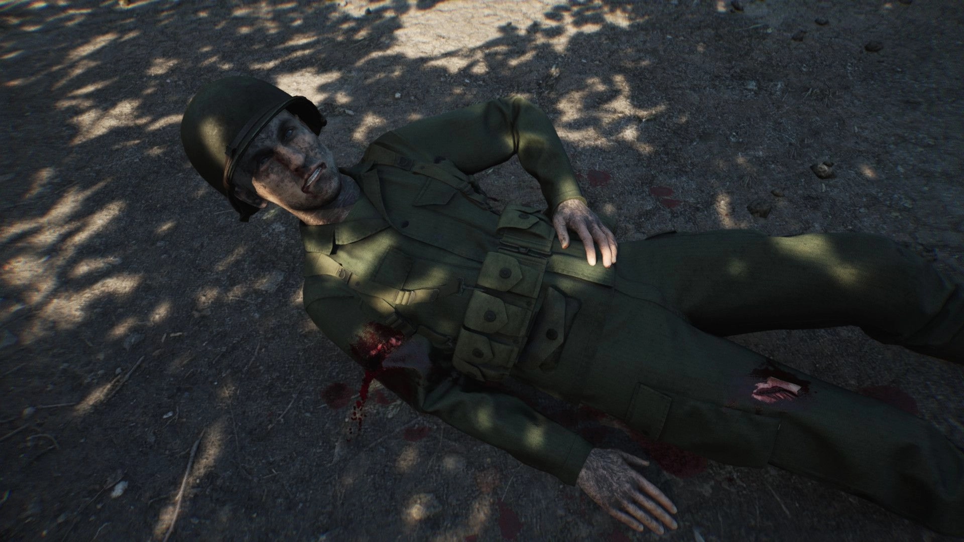 Medic: Wounded soldier lies on dirt ground with blood stains, sunlight filtering through tree branches