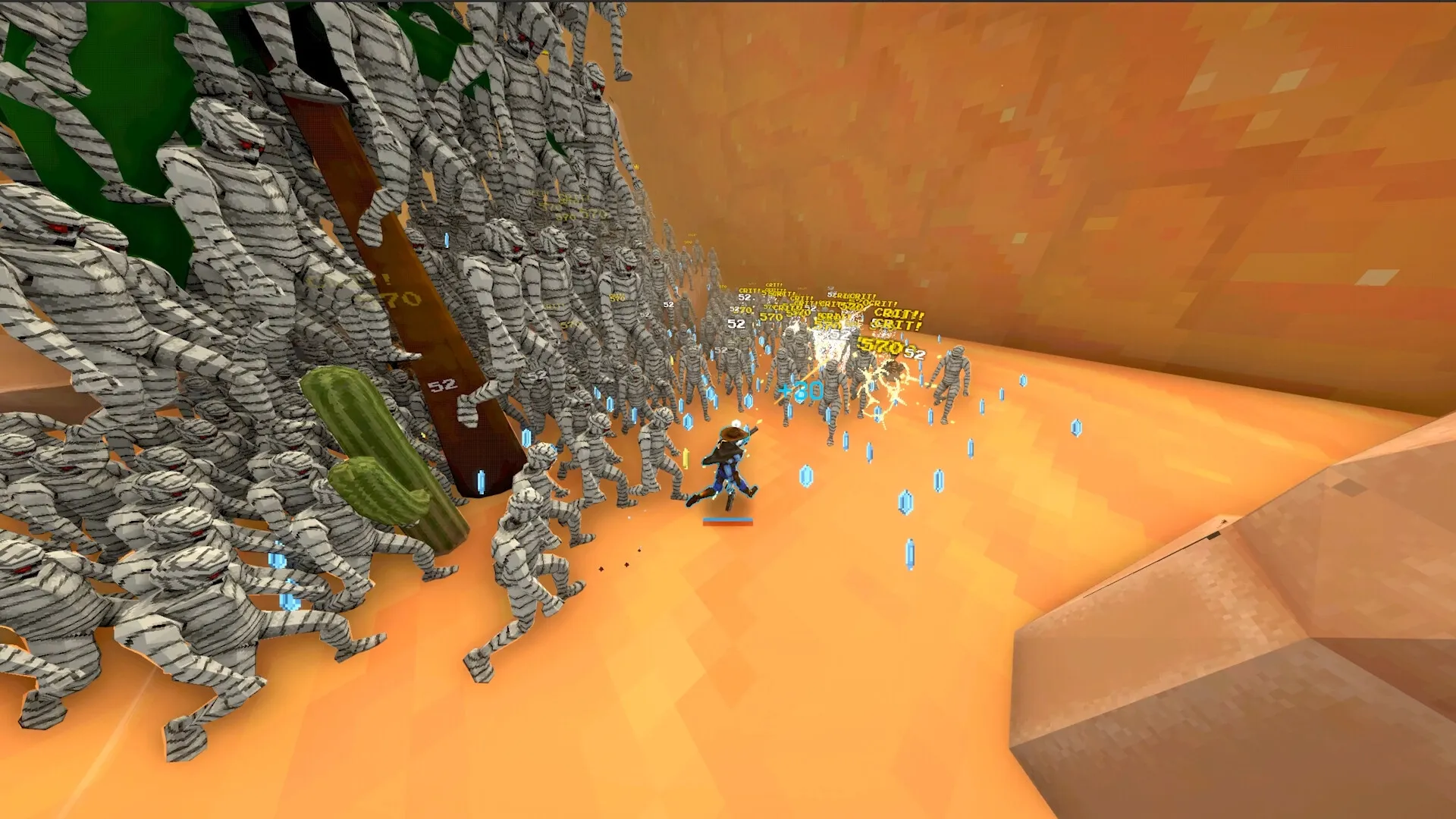 Megabonk: Player fights mummies in desert canyon, collecting blue gems and dealing critical damage.