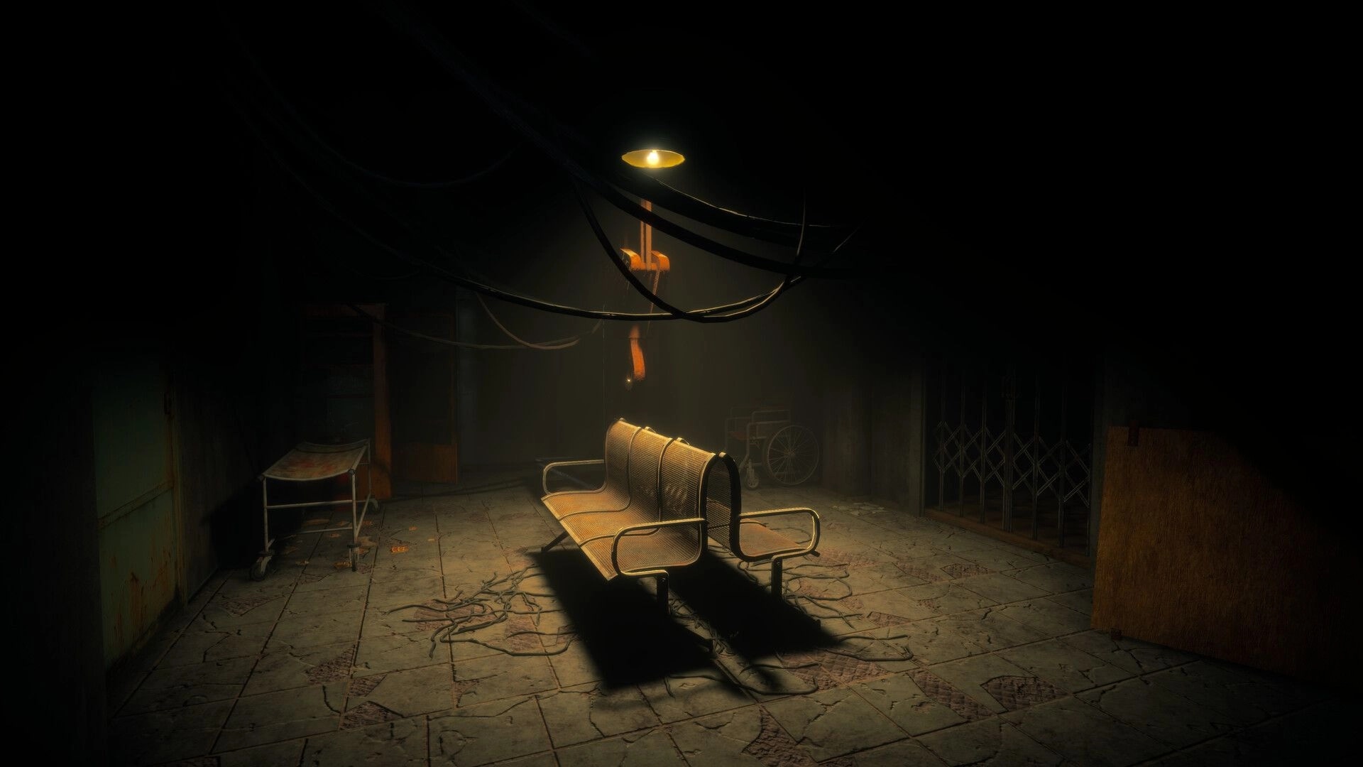 Menthal: Empty waiting room with metal bench and hanging cables under a dim ceiling lamp.