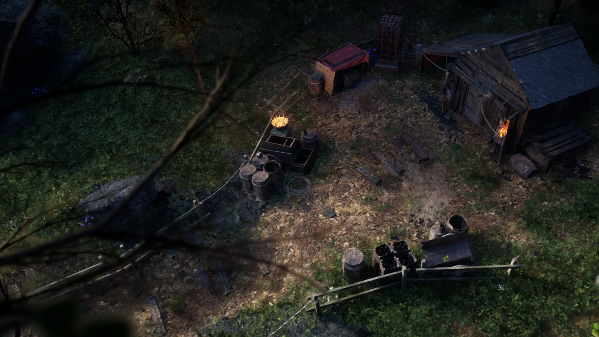 Menyr: Overhead view of a rustic camp with barrels, wooden shack, and glowing furnace in forest clearing