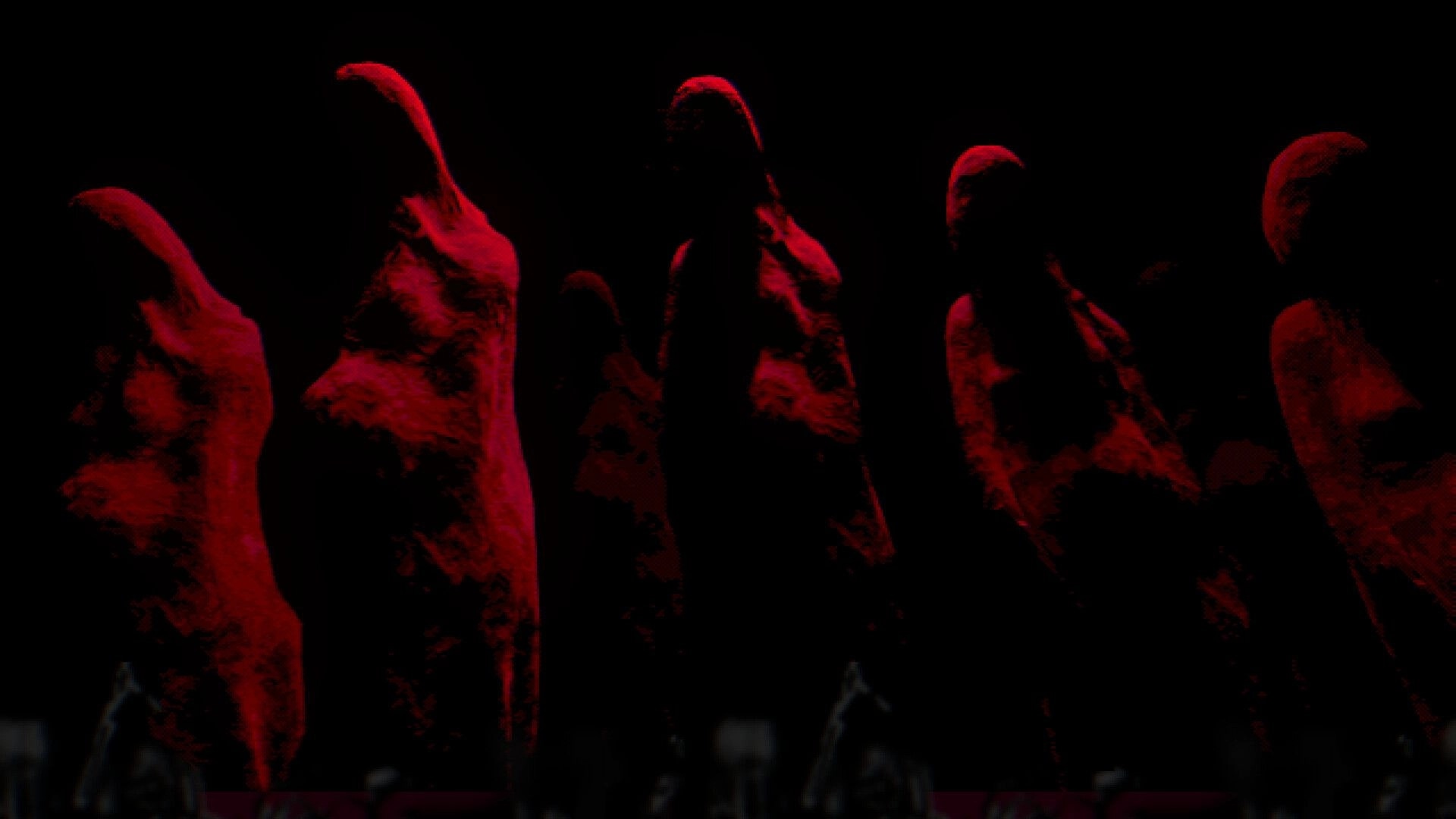METAMORPHOSIS: Hooded figures in red shrouds stand ominously in a dark, shadowy environment.