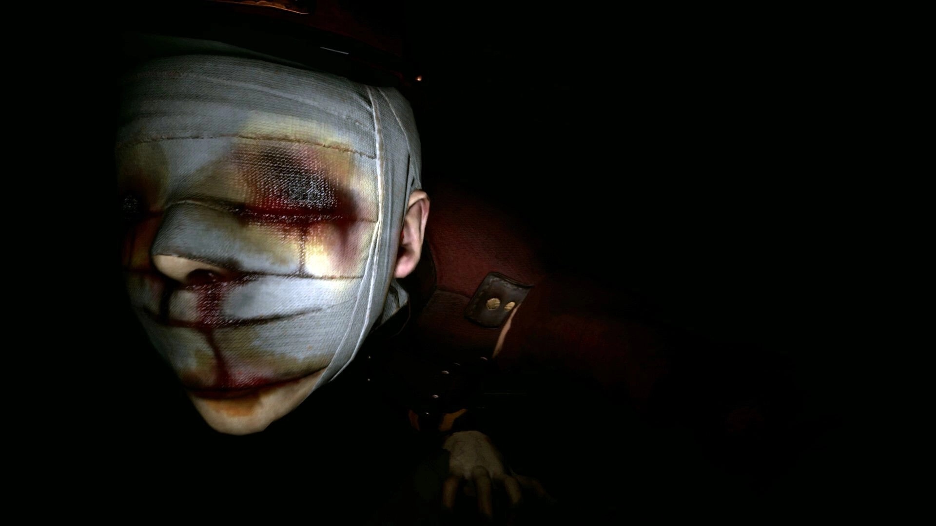 Michael Test: Close-up of a bandaged face with bruised eye, lit in a dark, shadowy room.