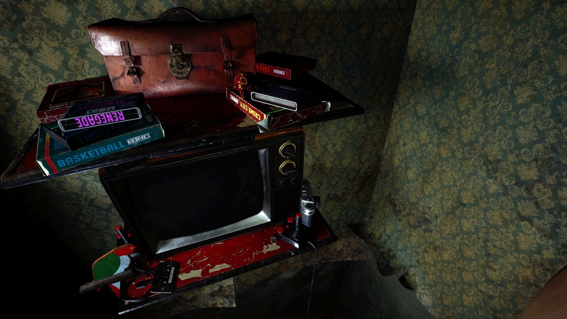 Michael Test: Old CRT TV with joystick and VHS tapes stacked on a shelf in a dusty wallpapered room.