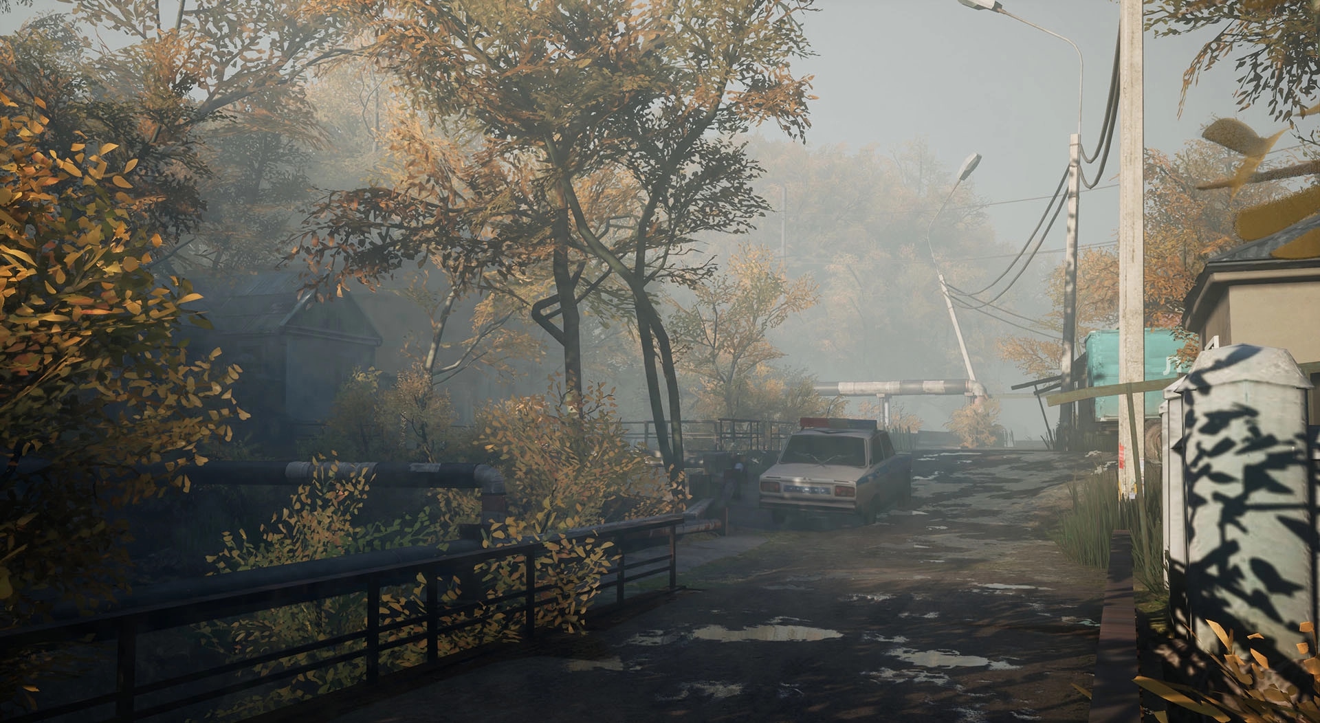 Militsioner: Abandoned street with autumn trees, old car, and misty atmosphere in a small village setting