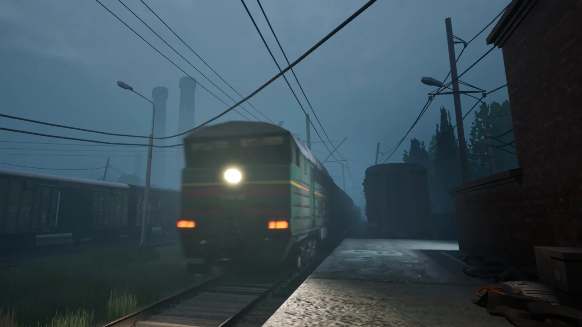 Militsioner: A train speeds through a foggy, industrial rail yard, wires and chimneys silhouetted in background.