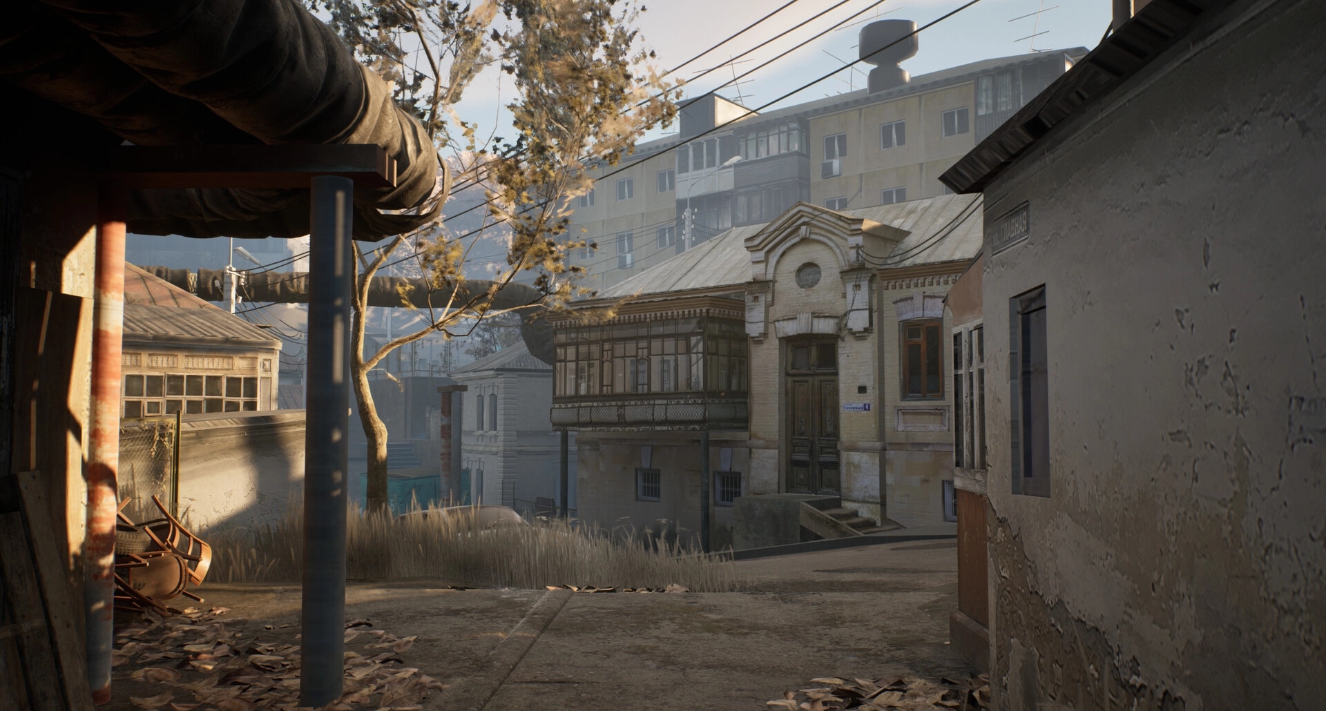 Militsioner: Quiet street with old buildings and scattered leaves under a clear sky in a small town setting.