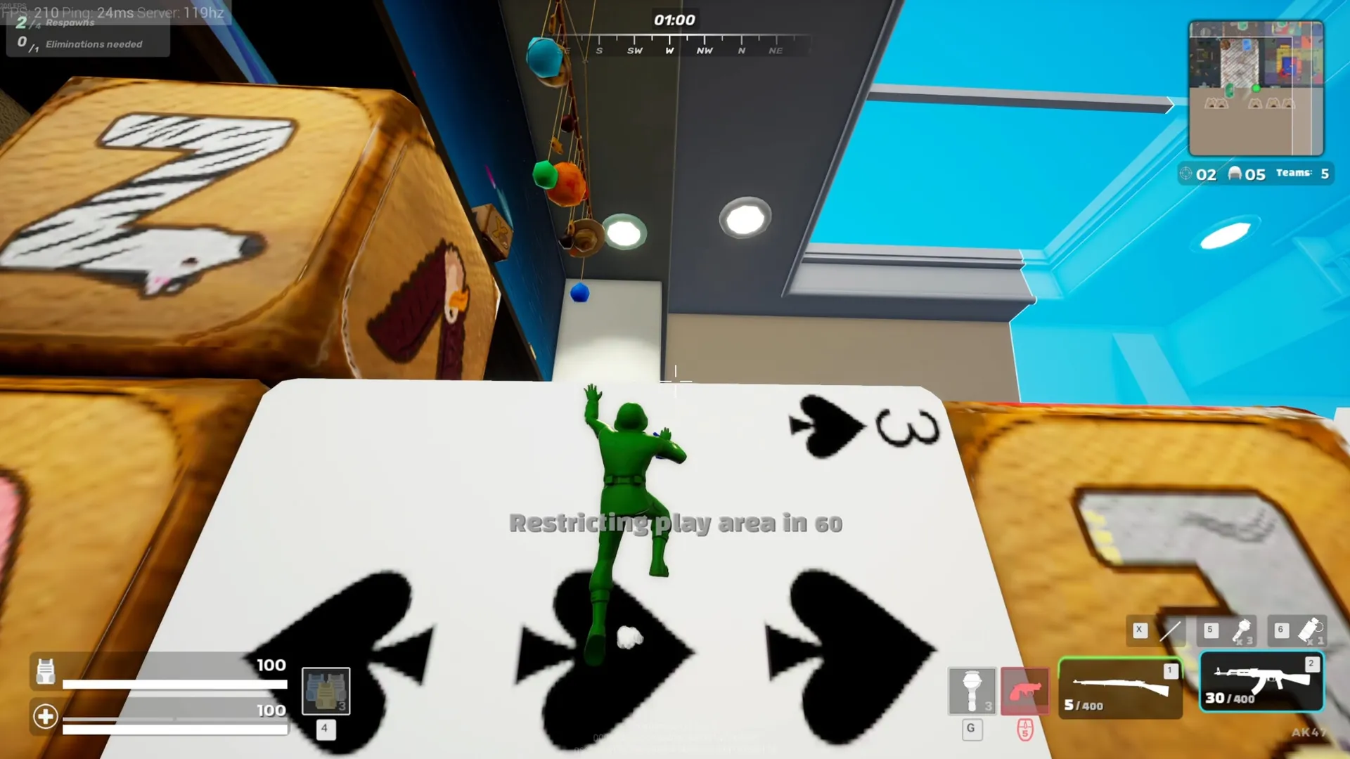 Mini Royale: Green soldier climbs playing cards in a kids' bedroom with UI health and ammo display