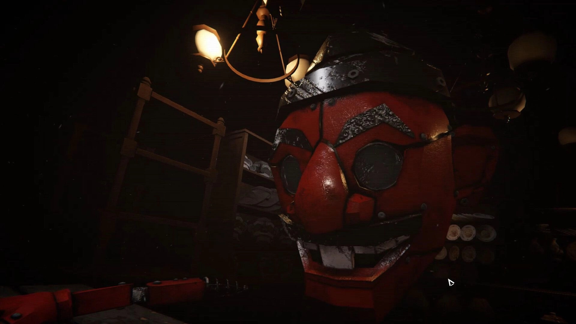 Mission Mancala: Close-up of cracked red puppet mask in a dim room with shelves and hanging lamp.